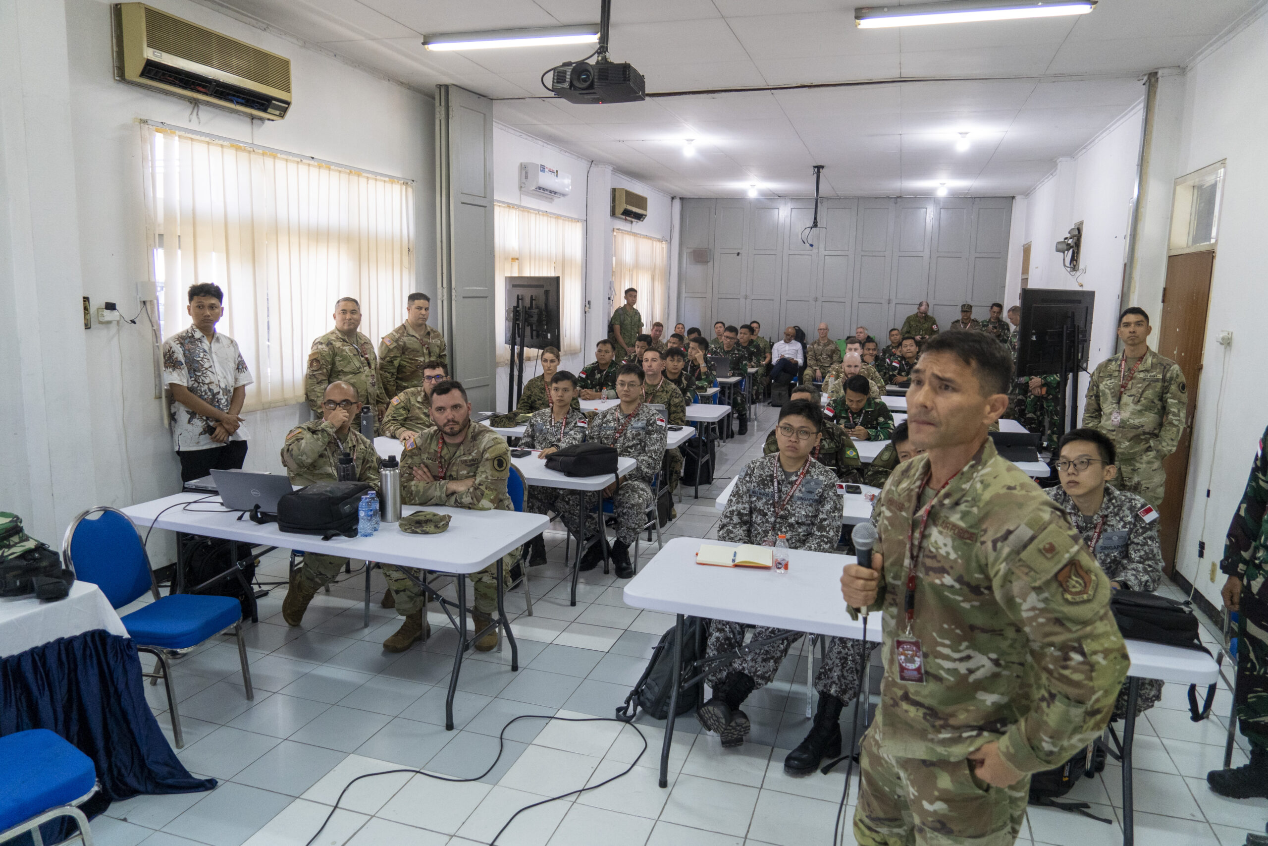 U.S. Air Force Col. Glen Hayase, commander of the 154th Mission Support Group, briefs multinational participants of a cyber exercise (CYBEREX), Aug. 26, 2024, Surabaya, Indonesia. The CYBEREX is part of Super Garuda Shield 2024, an Indonesia-led exercise intended to increase military interoperability between participating Allies and Partners, the United States military and the Indonesian Armed Forces. Super Garuda Shield 2024 is the third consecutive time this exercise has grown into a combined and joint event, focused on commitment to partnership and a Free and Open Indo-Pacific. (U.S. Air National Guard photo by Staff Sgt. Orlando Corpuz)