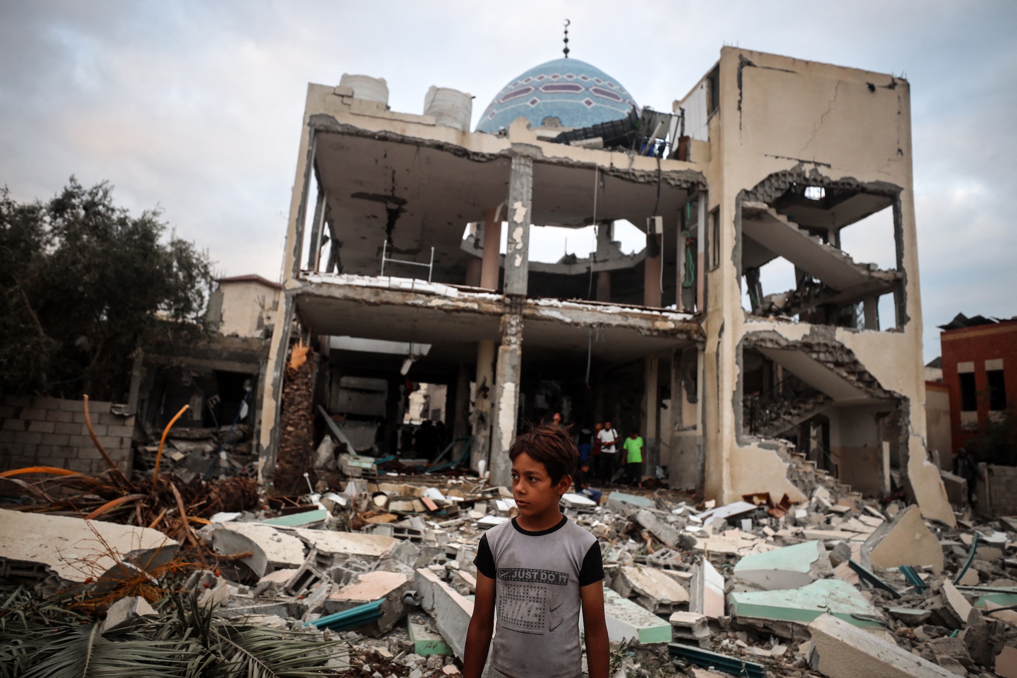A Palestinian inspects the damage to a mosque after it is hit in an Israeli strike in Deir al-Balah, central Gaza Strip, on October 6, 2024
