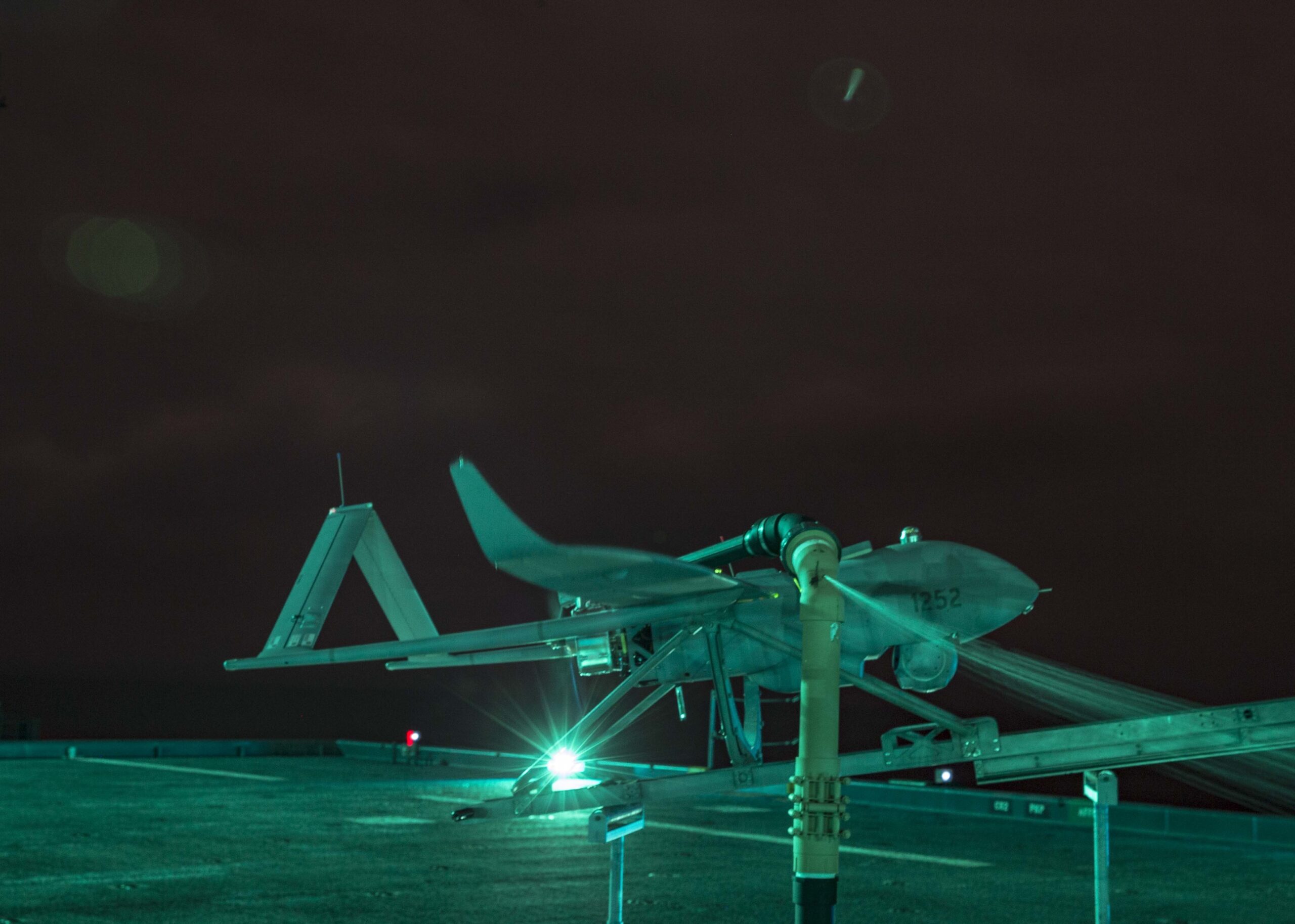 Aerosonde Unmanned Arial Surveillance (UAS) vehicle, Buck G, awaits to launch aboard the Expeditionary Sea-Base USS Hershel “Woody” Williams (ESB 4) in the Atlantic Ocean, Sept. 25, 2020. The UAS is piloted by Aerosonde personnel from the Hershel “Woody” Williams and provides live aerial surveillance to enhance the ship’s security. Hershel “Woody” Williams is on its inaugural deployment in the U.S. Naval Forces Europe-Africa area of responsibility in support of maritime missions and special operations. (U.S. Marine Corps photo by Sgt. Megan Roses/Released)