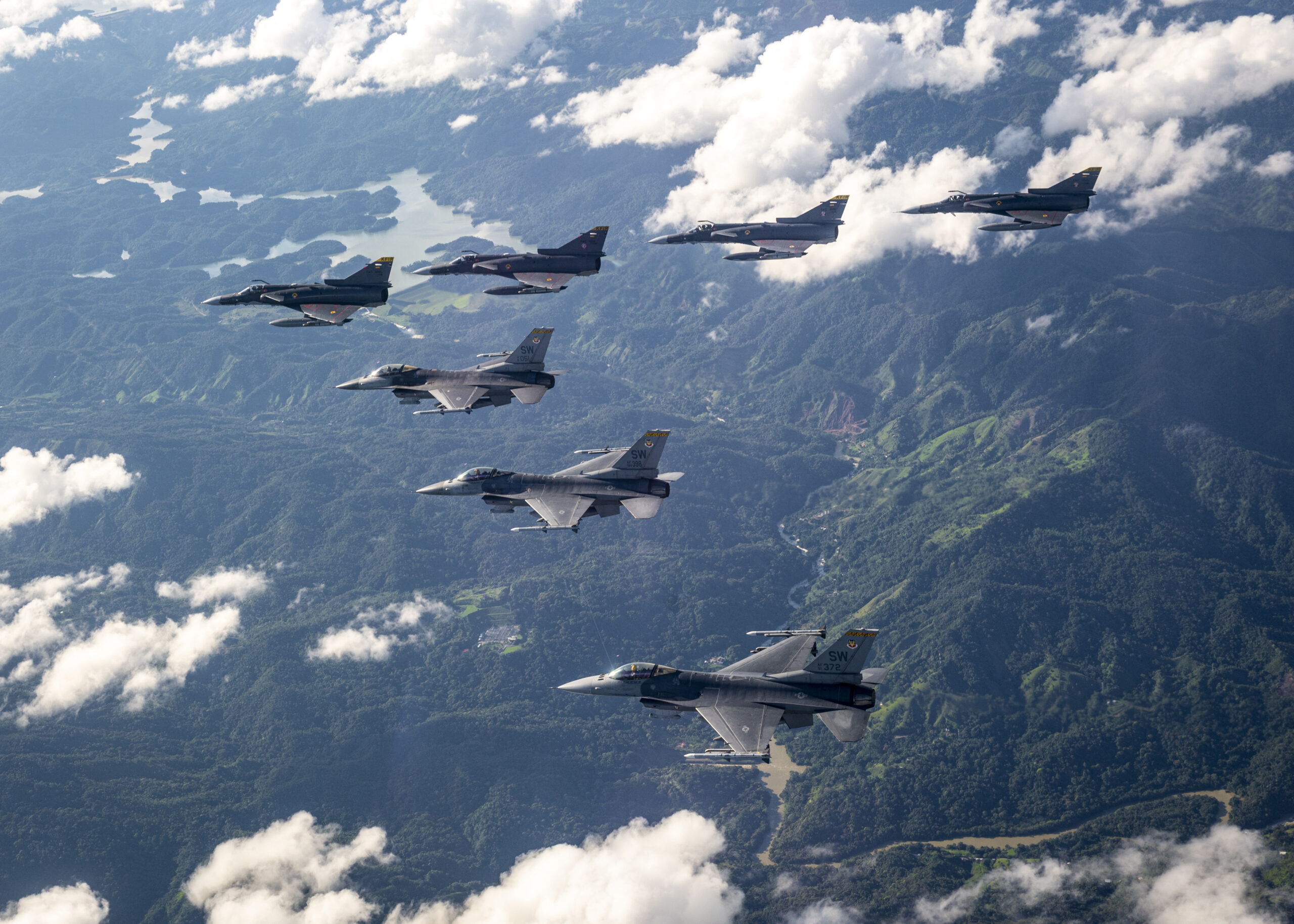 U.S. Air Force F-16 Fighting Falcons assigned to the 79th Expeditionary Fighter Squadron and Colombian Air Force Kfirs fly in formation over Colombia during Exercise Relampago VI, July 27, 2021. Colombian Air Force and United States Air Force aircraft will fly together and against one another in training using NATO standards to promote seamless interoperability. (U.S. Air Force photo by Senior Airman Duncan C. Bevan)