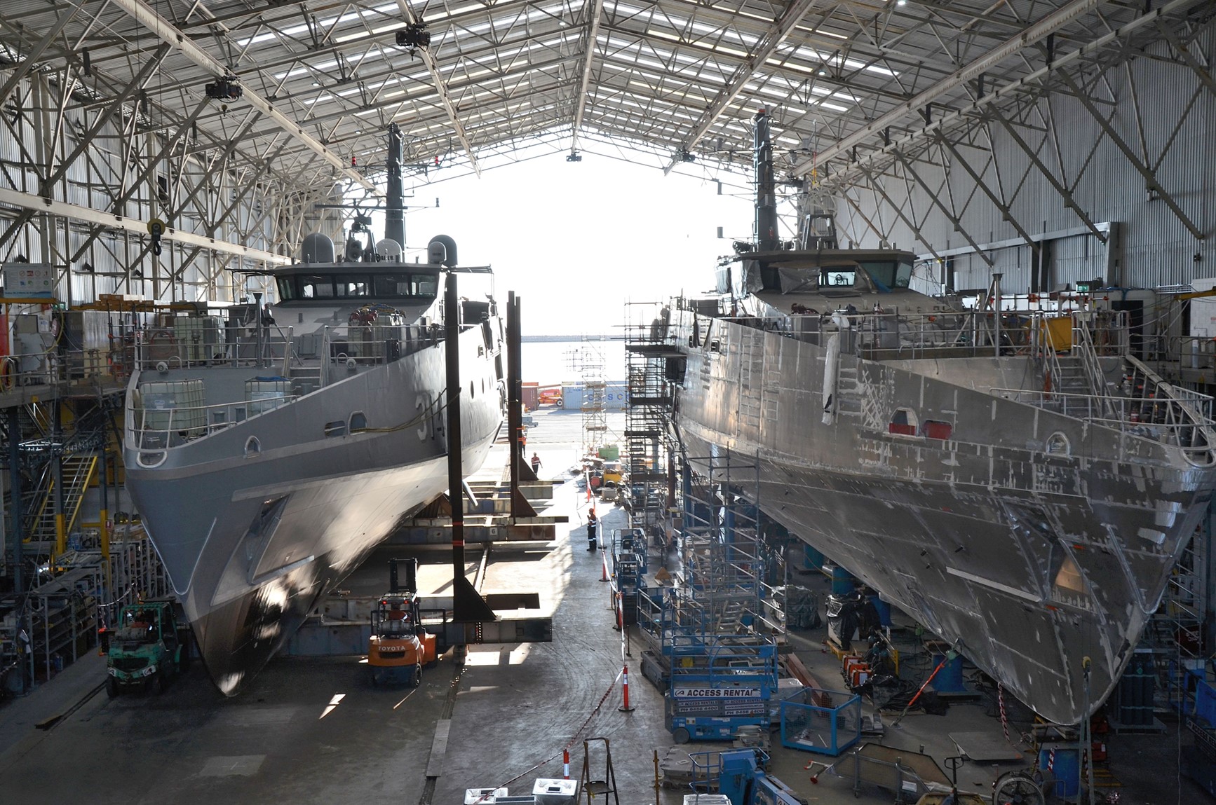 Hulls of two future Evolved Cape-class patrol boats under construction in a shipyard