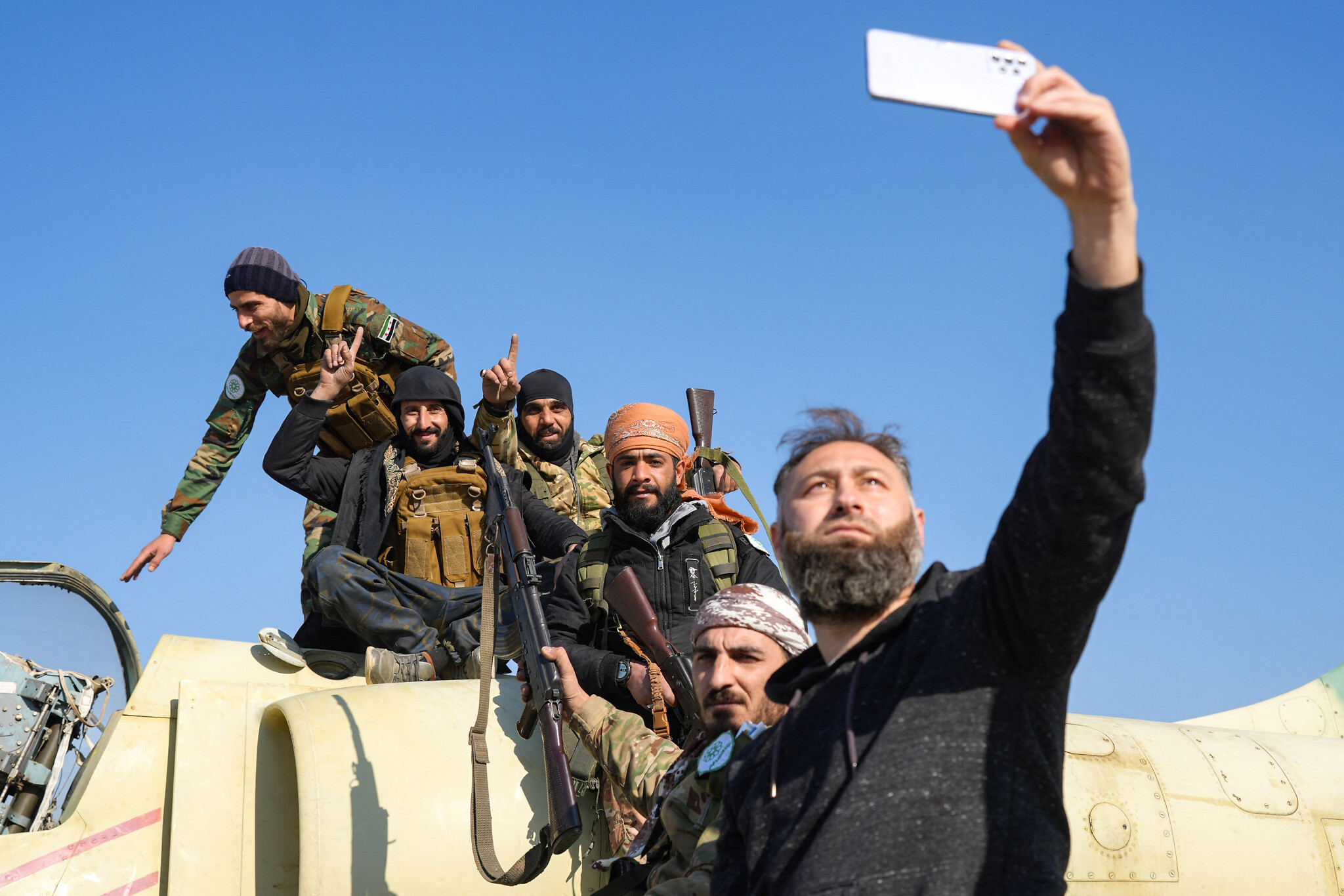 Anti-government fighters pose for a 