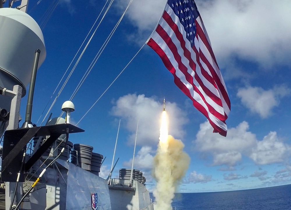 The Arleigh Burke-class guided-missile destroyer USS Barry (DDG 52) launches a Standard Missile (SM) 2 during a live-fire missile exercise