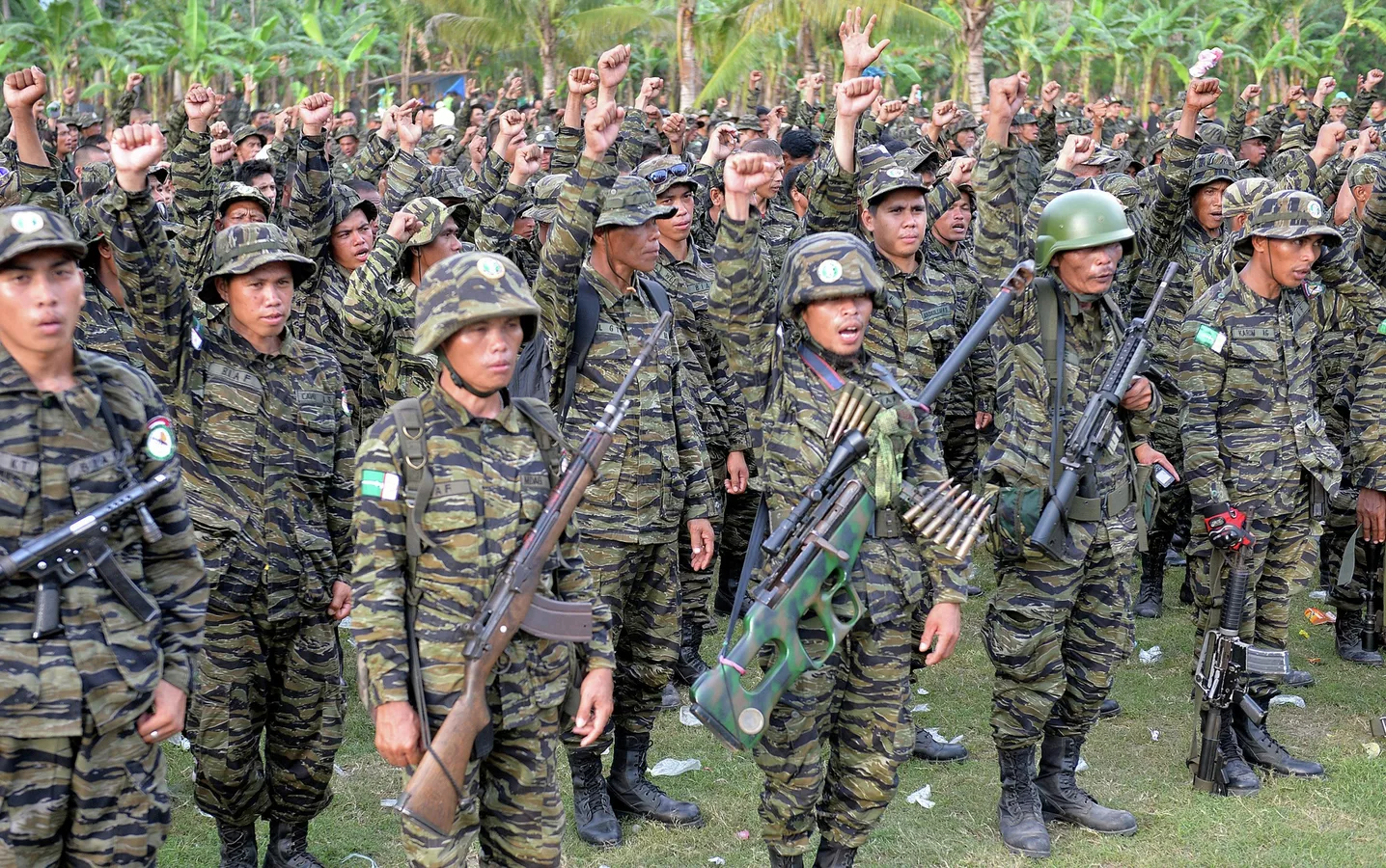 Members of the Bangsamoro Islamic Armed Forces (BIAF), armed wing of the Moro Islamic Liberation Front (MILF), gather inside one of their camps in Mindanao. TED ALJIBE | Credit: AFP [File Photo from Agence France-Presse (AFP)]