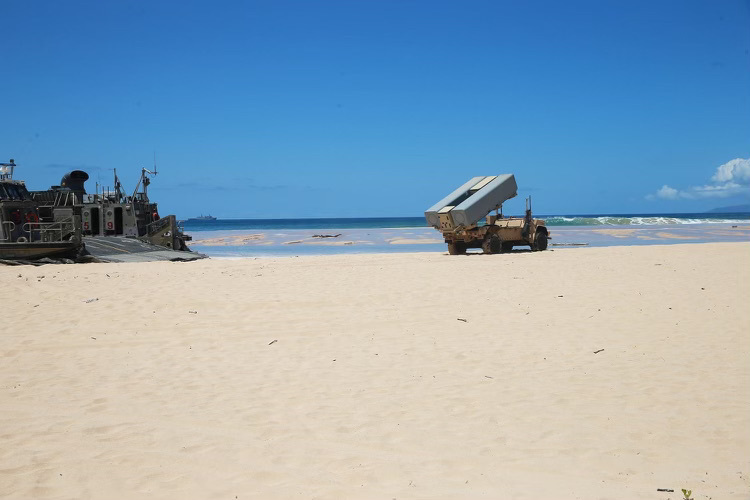 A Landing Craft Air Cushioned (LCAC) assigned to Assault Craft Unit Five (ACU-5) delivers a Navy Marine Expeditionary Ship Interdiction System launcher to Pacific Missile Range Facility Barking Sands, Hawaii as a part of Large Scale Exercise 2021.