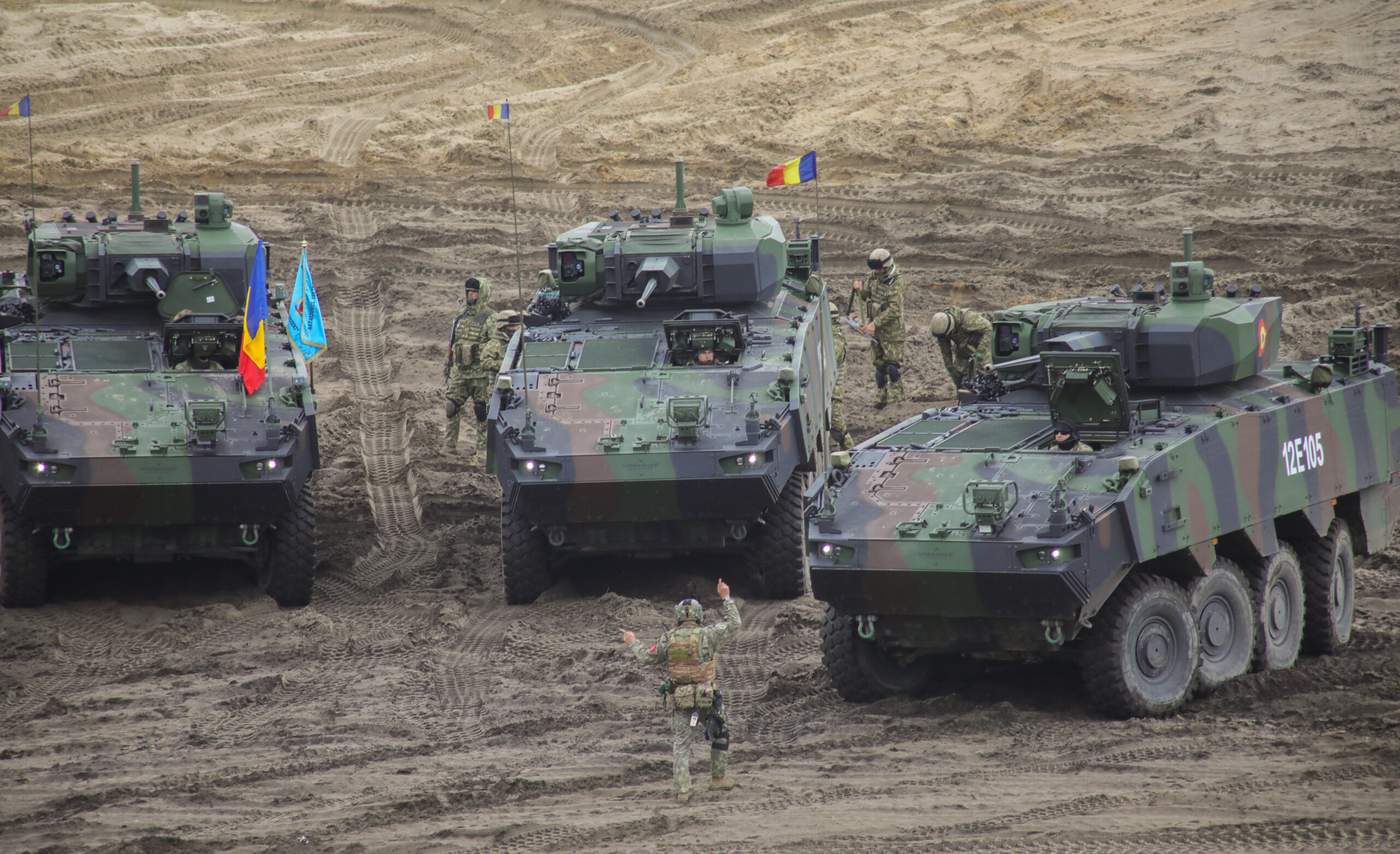 Romanian soldiers assigned to the Black Wolves, 151st Multinational Battle Group ground guide a Piranha V Infantry Fighting Vehicle in a combined arms live fire exercise during Anakonda23 at Nowa Deba, Poland, May 15, 2023. Anakonda23 is Poland's premier national exercise that strives to train, integrate and maintain tactical readiness and increase interoperability in a joint multinational environment, complimenting the 4th Inf. Div.'s mission in Europe, which is to participate in multinational training and exercises across the continent while collaborating with NATO allies and regional security partners to provide combat-credible forces to V Corps, America's Forward deployed corps in Europe. (U.S. Army National Guard photo by Sgt. 1st Class Theresa Gualdarama)