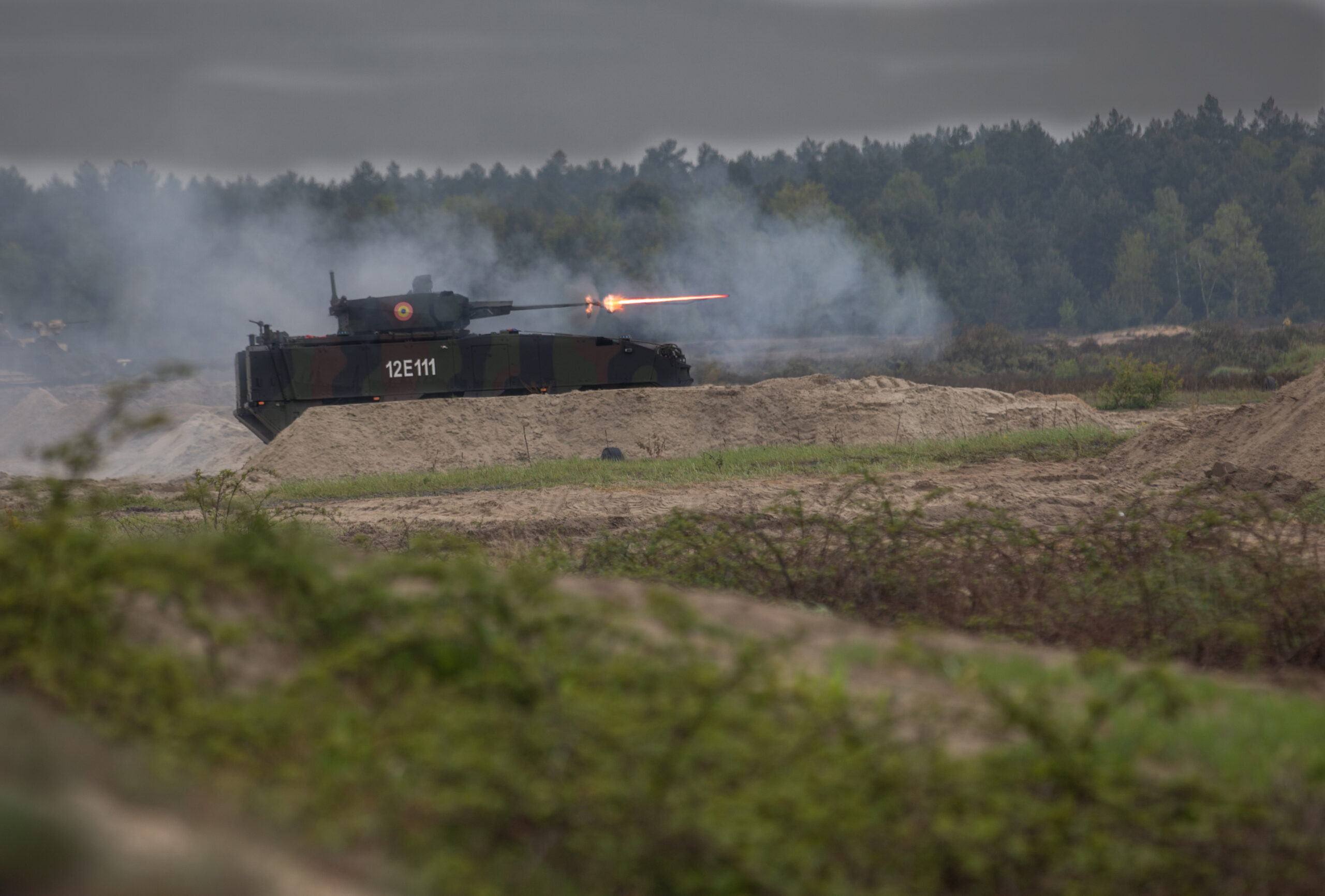 A Romanian Piranha V Infantry Fighting Vehicle fires rounds down range during Anakonda23 live fire training exercise at Nowa Deba Training Area, Poland, May 15, 2023. Anakonda23 is Poland's premier national exercise that strives to train, integrate and maintain tactical readiness and increase interoperability in a joint multinational environment, complimenting the 4th Inf. Div.'s mission in Europe, which is to participate in multinational training and exercises across the continent while collaborating with NATO allies and regional security partners to provide combat-credible forces to V Corps, America's Forward deployed corps in Europe. (U.S. Army photo by Pfc. Jason Klaer)