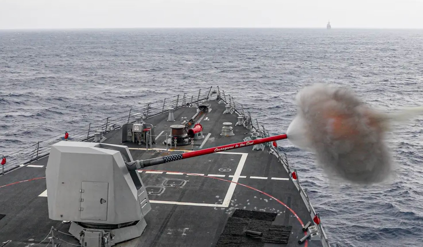 The Arleigh Burke-class guided-missile destroyer USS Rafael Peralta (DDG 115) fires its Mk 45 5-inch gun.