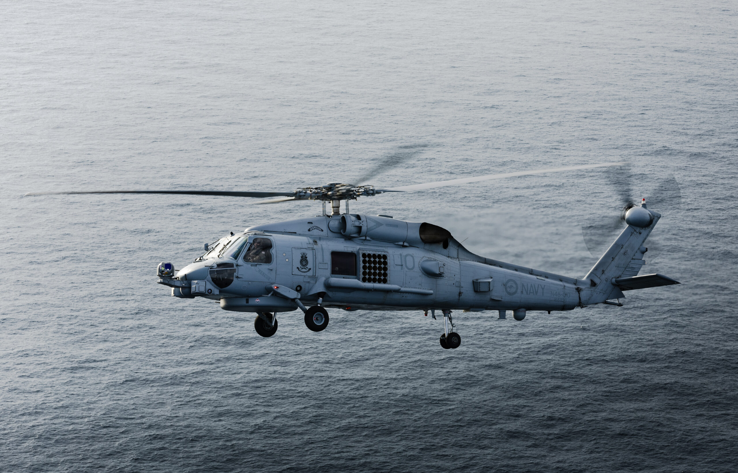 Royal Australian Navy replenishment ship HMAS Stalwarts embarked MH-60R Seahawk helicopter Boomerang conducts flying operations during a transit as part of a regional presence deployment. *** Local Caption *** The Royal Australian Navy is undertaking a regional presence deployment in Southeast and Northeast Asia. During the deployment, HMA Ships Toowoomba, Stalwart and Brisbane demonstrated the Royal Australian Navys ability to execute sustained operations in the deployed environments through superior Replenishment at Sea capability. During this evolution, Stalwart completing her first dual Replenishment at Sea evolution providing HMA Ships Toowoomba and Brisbane with F76 fuel, and F44 fuel for the embarked MH-60R Helicopters. Concurrently, Stalwart launched her embarked MH-60R helicopter, Boomerang, to conduct a Vertical Replenishment of stores and mission-essential equipment to Toowoomba. Regional presence deployments demonstrate Australias commitment to, and engagement with, the region. The deployments play a vital role in Australias long-term security and prosperity by protecting Australias interests, preserving a rules-based order, enhancing cooperation and relationships with regional partners and allies, and developing capability and interoperability.