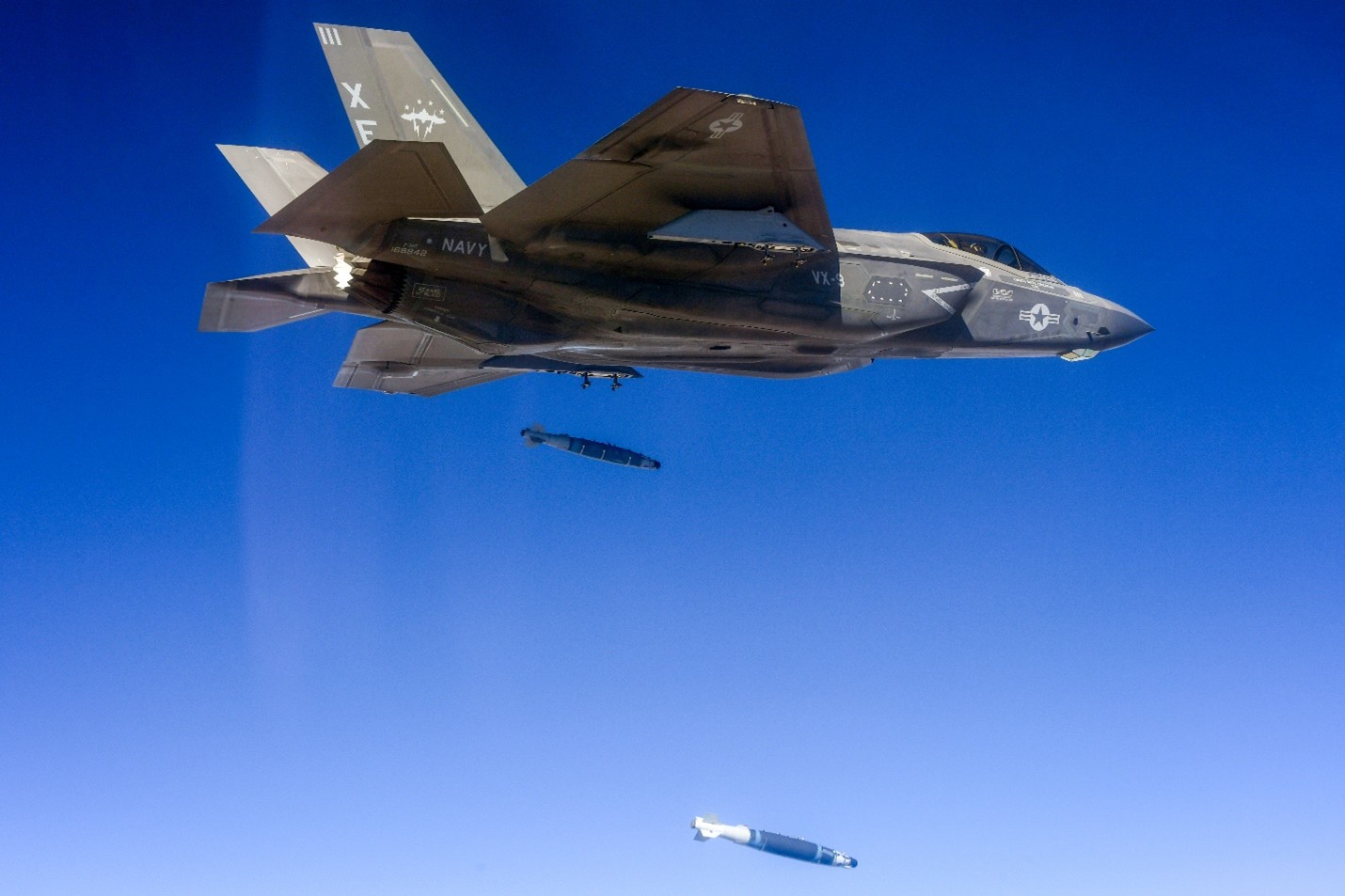 An F-35C aircraft performs a dual, external release of a GBU-54.