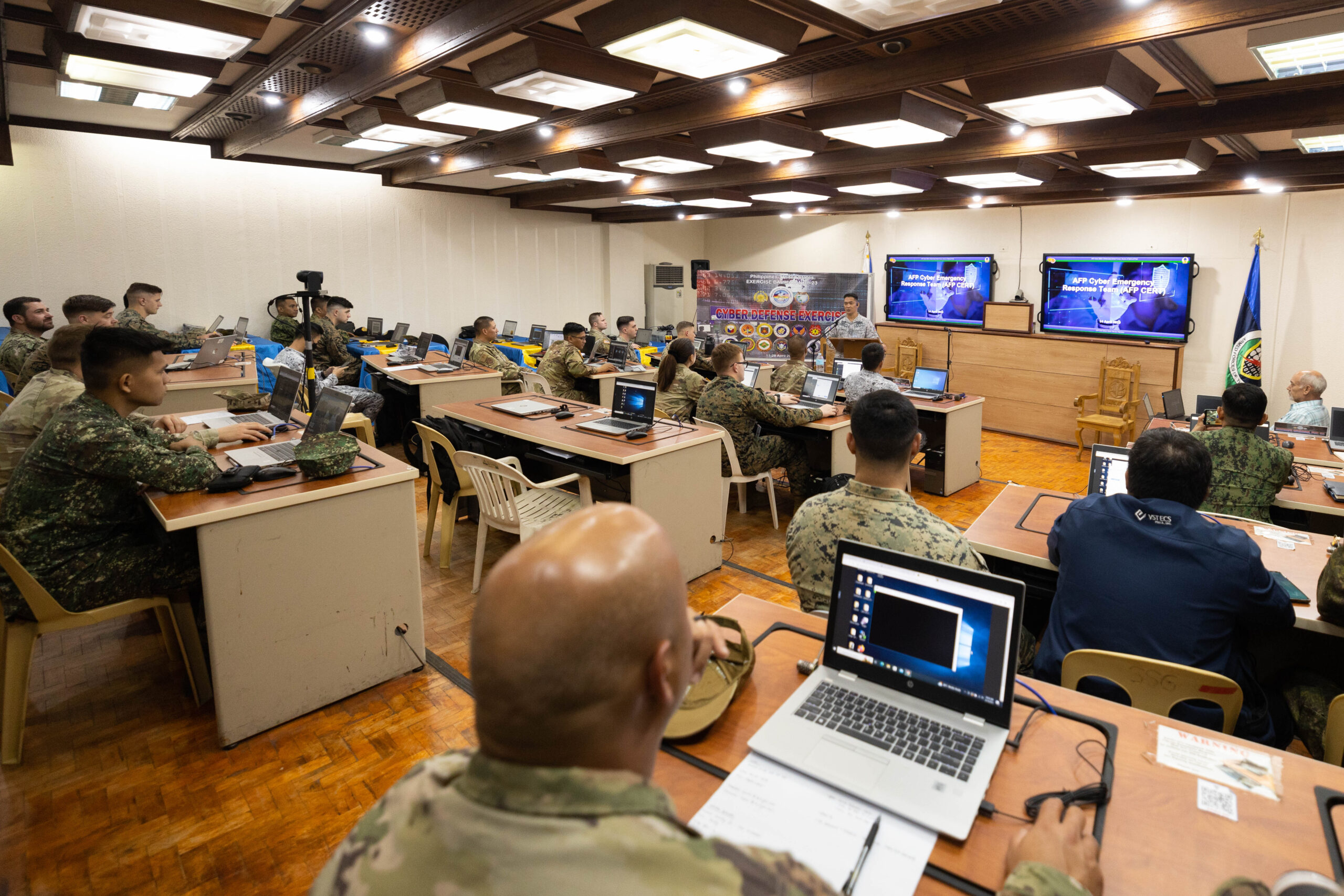 U.S. and Philippine service members with the Cyber Defense Exercise attend their final classroom lecture during exercise Balikatan 23 at Camp Aguinaldo, Philippines, April 14, 2023. Balikatan 2023, the 38th iteration of the annual bilateral exercise between the Armed Forces of the Philippines and the U.S. military, featured an inaugural joint, bilateral cyber defense exercise. Five teams of cyber defense experts defended a simulated military network, critical civilian infrastructure and other digital nodes from simulated malign actors such as criminal gangs, hacker collectives and a fictitious nation-state. Balikatan provides a venue to modernize the U.S. Philippine Defense Alliance, and improve collective capabilities and interoperability. (U.S. Marine Corps photo by Cpl. Fred Garcia)