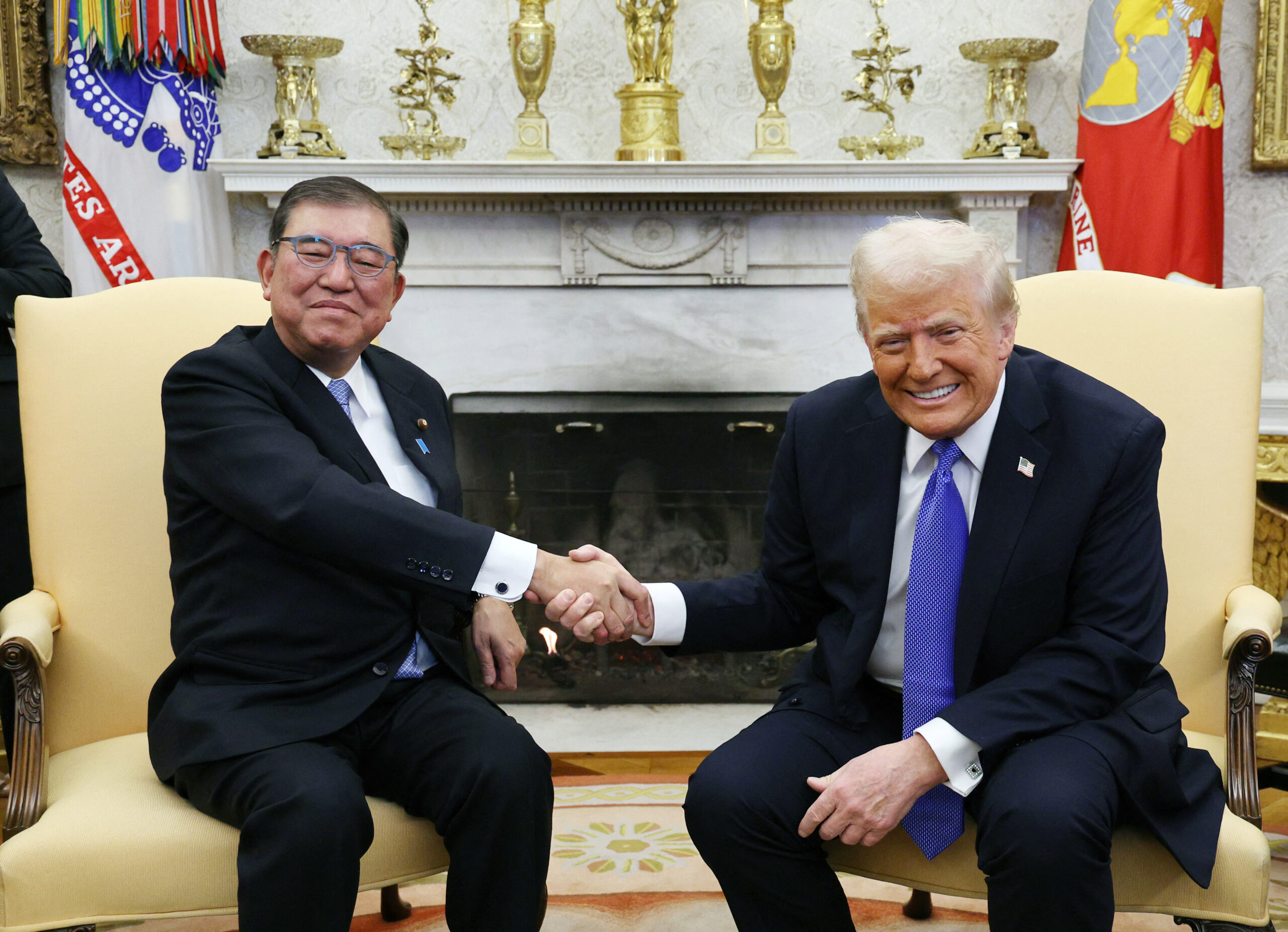 Japanese Prime Minister Shigeru Ishiba (L) and U.S. President Donald Trump shake their hands during a bilateral meeting at the White House in Washington D.C., United States of America, on February 7, 2025. ( The Yomiuri Shimbun ) (Photo by Nanako Sudo / Yomiuri / The Yomiuri Shimbun via AFP)
