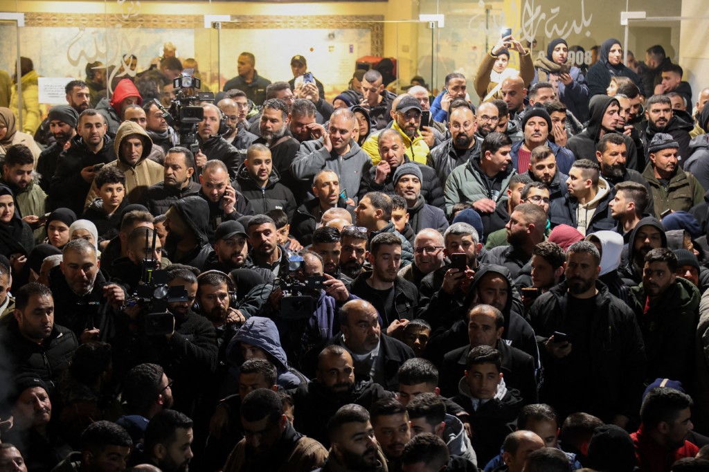 People and media members gather to welcome dozens of Palestinian prisoners released from Israel's prisons in return for the handover of bodies of 4 Israeli hostages by Hamas to the Red Cross in Ramallah, West Bank on February 26, 2025. (Photo by Mohammad Nazal / Middle East Images / Middle East Images via AFP)