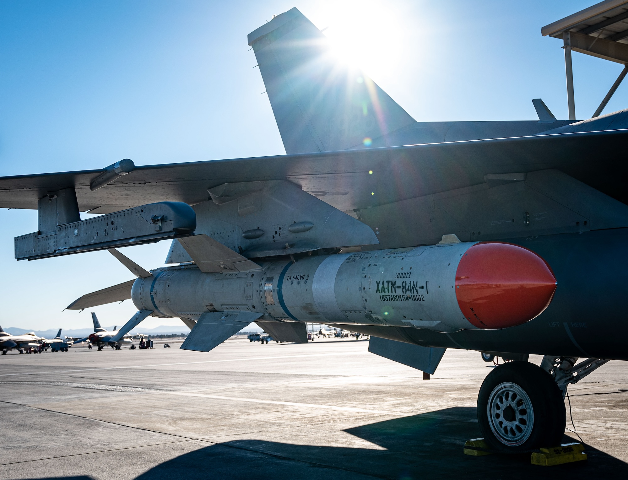 An F-16 Fighting Falcon assigned to the 53rd Test and Evaluation Group parks after taxing with a US Navy Harpoon missile system equipped at Nellis Air Force Base, Nevada