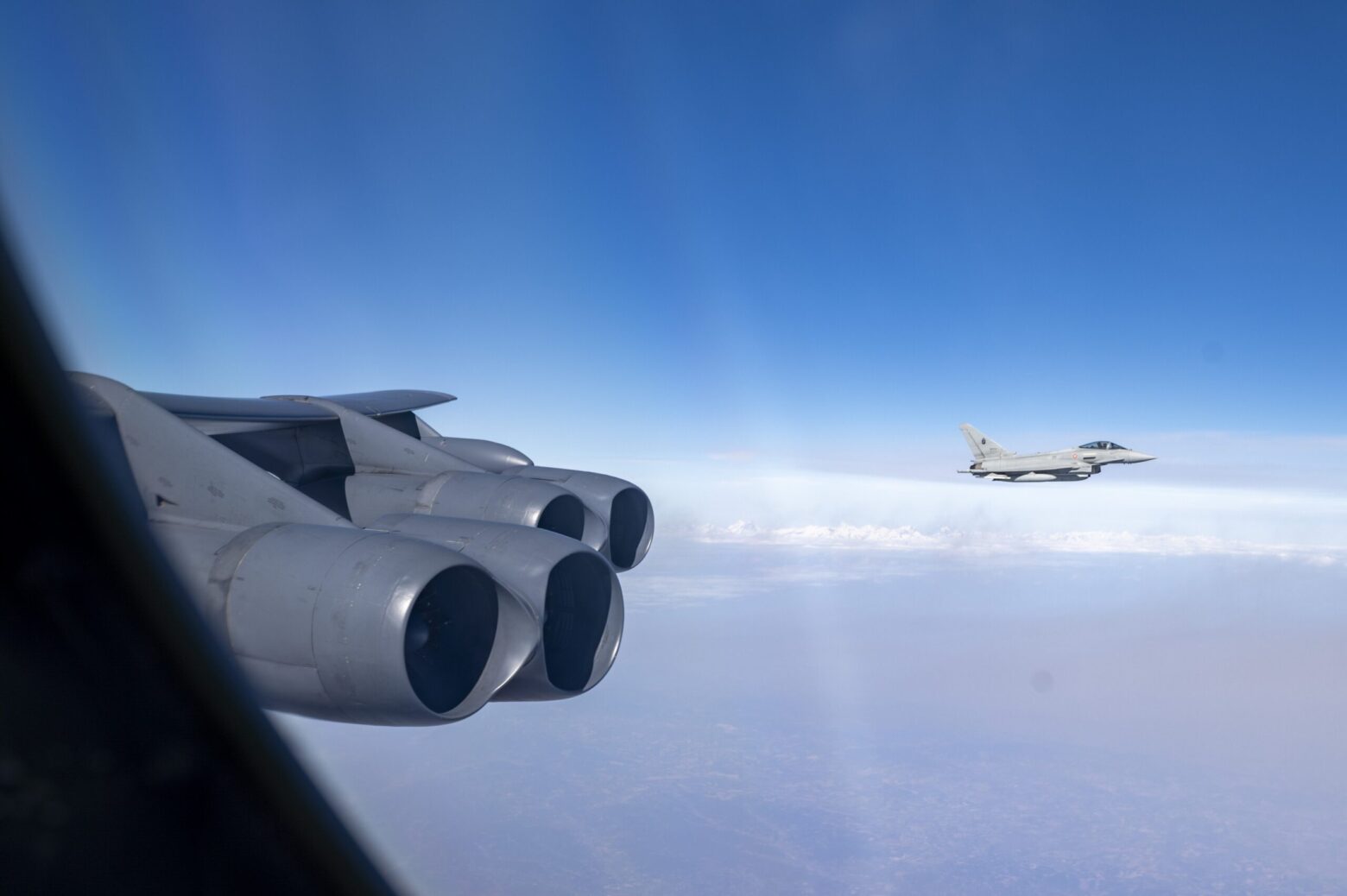 A Eurofighter Typhoon flies alongside a B-52H Stratofortress aircraft during bomber task force mission SPARTAN MACE.