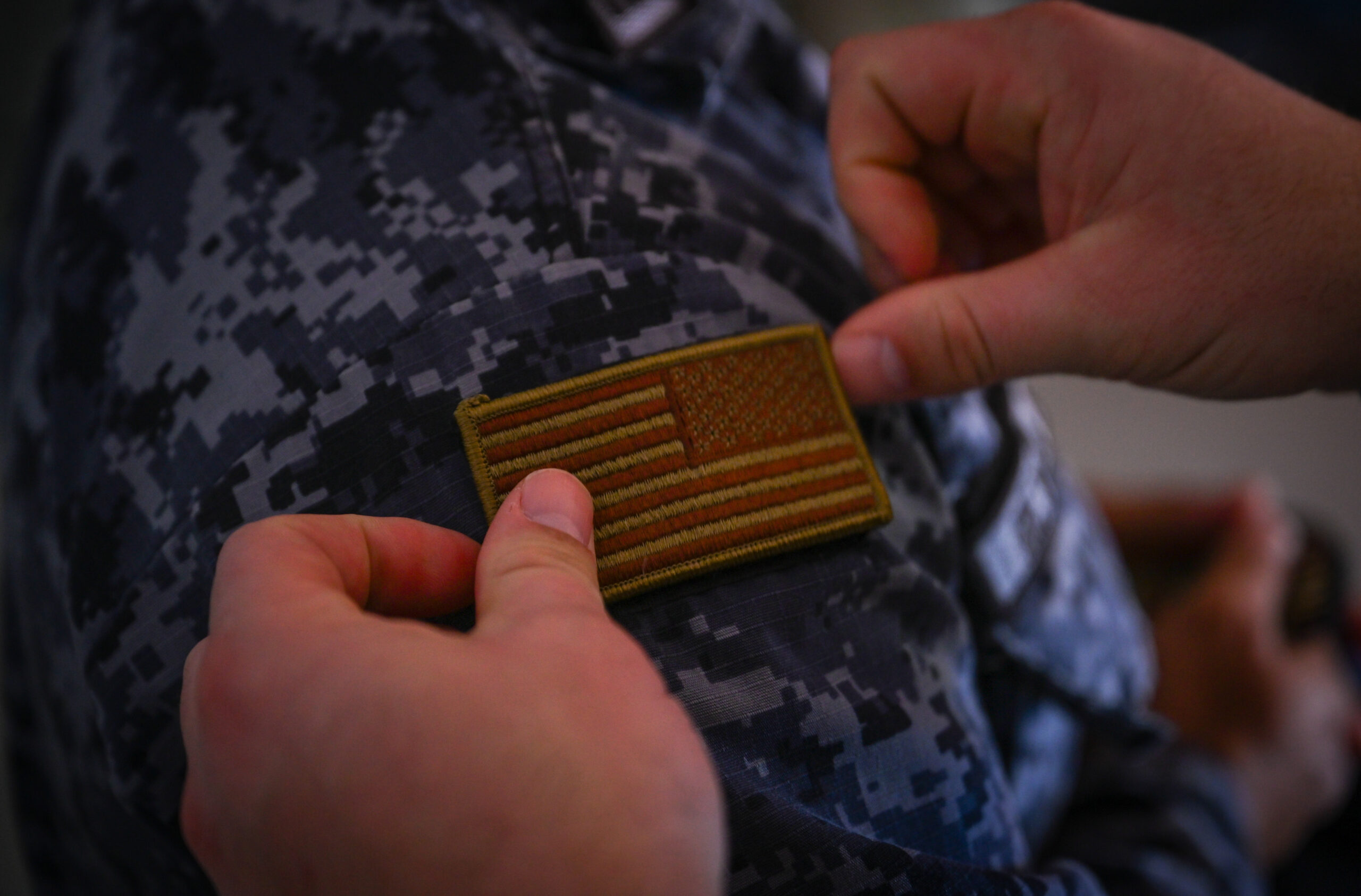 U.S. Air Force Master Sgt. Eddie Morgan, 571st Mobility Support Squadron training operations superintendent, puts a U.S. flag patch on Cápitan 2do. De Infantería Erlin Omar Reyna De Leon with Comando Aéreo Central (CACEN) for a tradition of trading patches and as a sign of respect after a base tour concluded at CACEN “La Aurora” in Guatemala City, Guatemala, Feb. 20, 2024. Guatemala 23-23 was a month-long training mission between the 571st Mobility Support Advisory Squadron’s mobile training team and the Guatemalan Air Force that was centered around logistics readiness, material management and aircraft maintenance. (U.S. Air Force photo by Staff Sgt. Scott Warner)