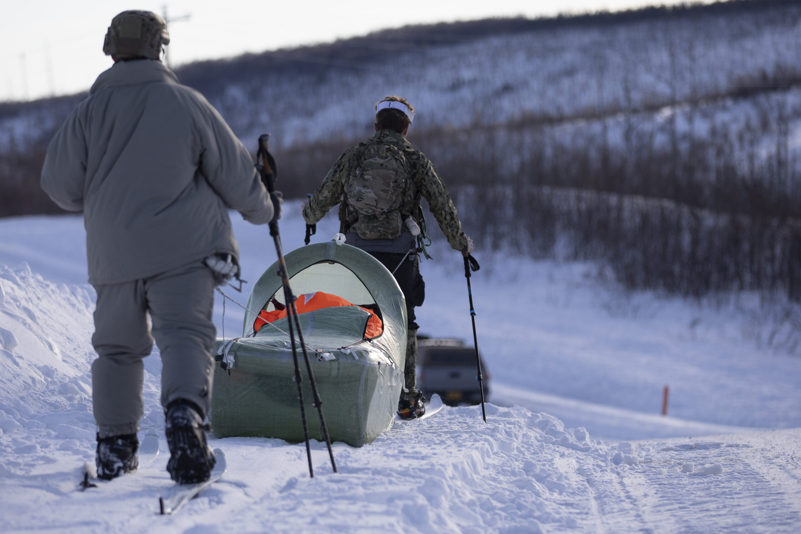 Exercise Special Operations Forces Arctic Medic 2025 participants transport a simulated combat casualty using a CASEVAC Ecosystem sled prototype during Special Forces Arctic Medic 2025 at Yukon Training Area, Alaska, Feb. 18, 2025. SOFAM 2025 prepares medics to operate in arctic or extreme cold environments and to provide safe medical care in a “bubble of warmth” in austere conditions. (Alaska National Guard photo by Seth LaCount)