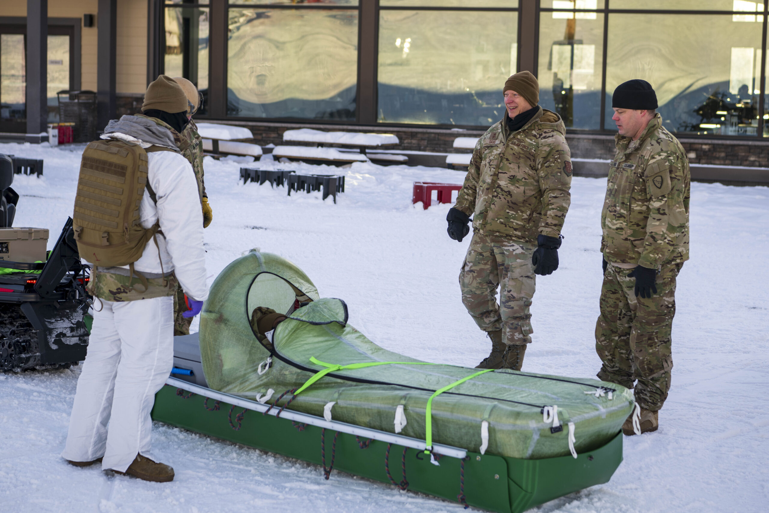 Maj. Gen. Torrence Saxe, Alaska National Guard adjutant general, observes the CASEVAC Ecosystem sled attached to the back of a snow mobile during Special Operations Forces Arctic Medic (SOFAM) 2025 at Fort Wainwright, Alaska, Feb. 12, 2025. SOFAM 2025 prepares medics to operate in arctic or extreme cold environments and provide safe medical care in a “bubble of warmth” in austere conditions. (U.S. Navy Photo by Mass Communications Specialist 1st Class Trey Hutcheson)