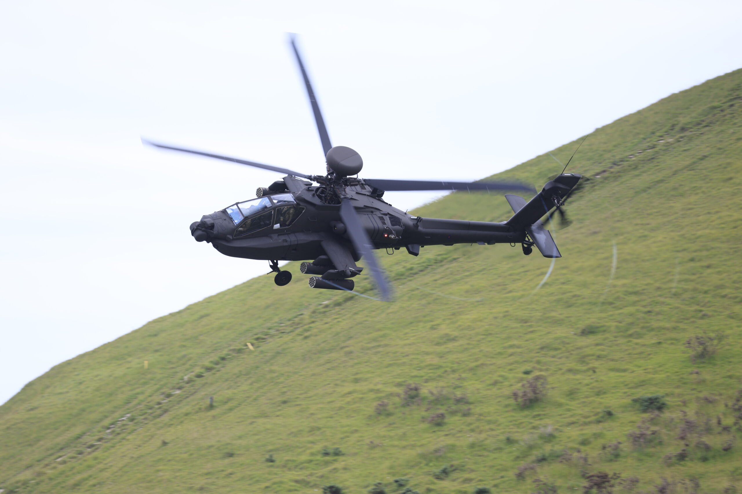 Image of a Apache AH-64E helicopter, seen here being demonstrated at Lulworth Range in the UK. A multi-domain immersive experience showcasing military equipment and capabilities took place at Lulworth Range, ahead of the Defence Command Paper refresh. The event was attended by Minister for the Armed Forces James Heappey, Chief of the General Staff General Sir Patrick Sanders and Chief of the Defence Staff Admiral Sir Tony Radakin. As well as demonstrating some of the cutting-edge equipment being used by the British military, the activity showcased integrated tactics and combined arms warfare. Other developing capability demonstrated included remote medical support and counter-unmanned aerial systems technology. The RAF's F35 fast jet and A400M transport aircraft were part of demonstrations, along with other equipment from across the three single services including Merlin and Apache helicopters and a Challenger 2 main battle tank. The demonstration featured personnel and equipment from units including 4 Light Brigade Combat Team; Future Commando Force (30 Commando Royal Marines); 4 Ranger from the Army Special Operations Brigade; 11 Group RAF; Experimental and Trial Group (ETG) consisting of elements from 2YORKS, the Next Generation Combat Team; elements of 16 Air Assault Brigade Combat Team HQ and Medical Regiment.