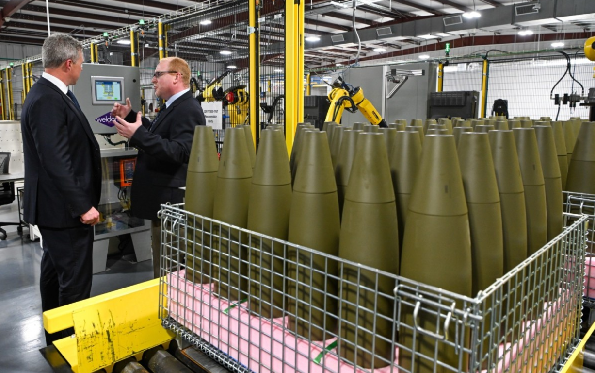 The newly opened Load, Assemble, and Pack (LAP) facility in Camden, Arkansas. A group of 155mm ammunition can be seen in the foreground, neatly placed in a raised platform.