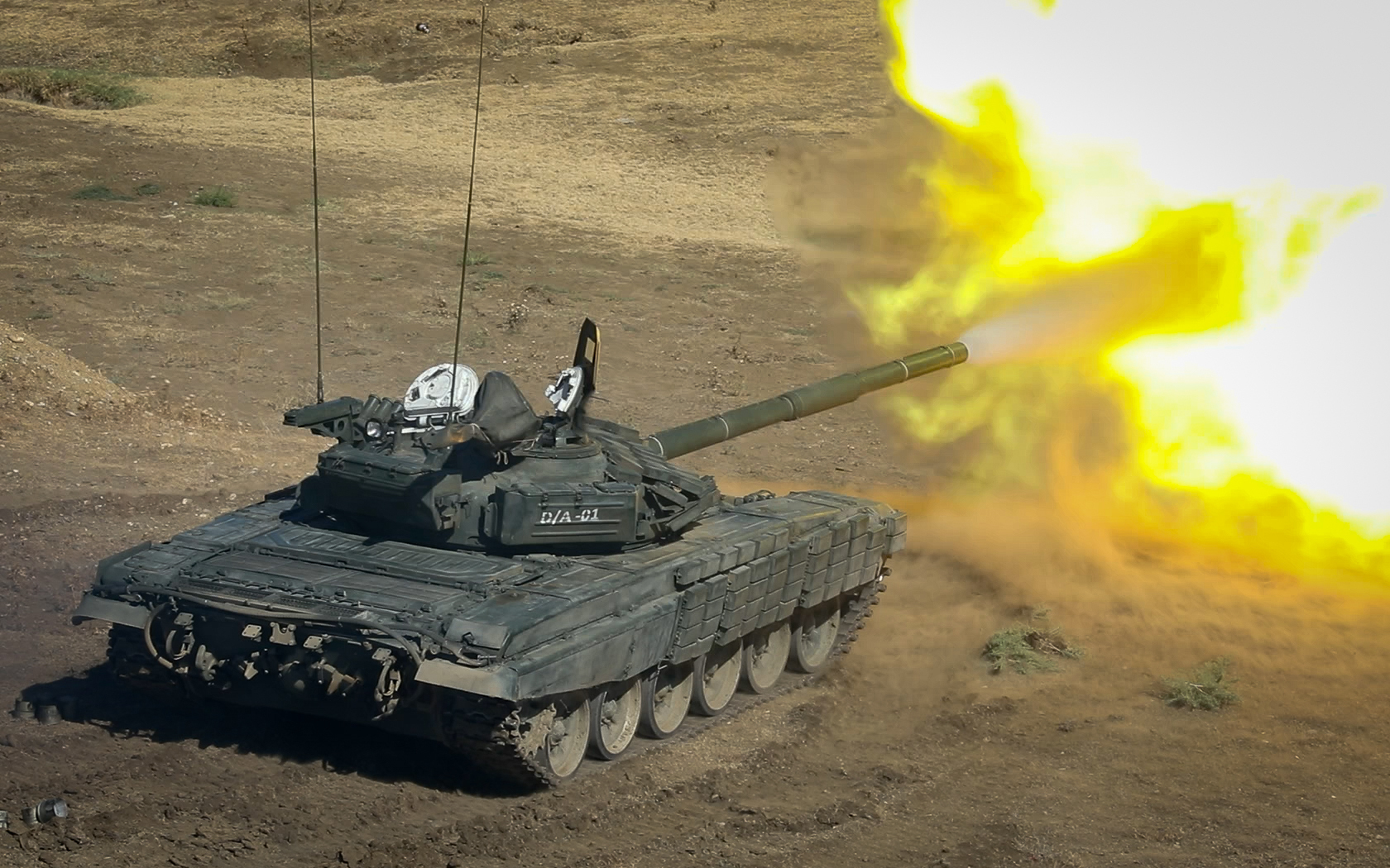 A Georgian Armed Forces T-72 tank fires during a combined arms live fire demonstration at the Vaziani training area in the country of Georgia, Sept. 9, 2022. Noble Partner 22 builds multinational interoperability between allied and partner nations, increasing readiness and improving multinational command and control capabilities. 12 CAB is among other units assigned to V Corps, America's Forward Deployed Corps in Europe. They work alongside NATO Allies and regional security partners to provide combat-ready forces, execute joint and multinational training exercises, and retain command and control for all rotational and assigned units in the European Theater. (U.S. Army photo by Staff Sgt. Thomas Mort)