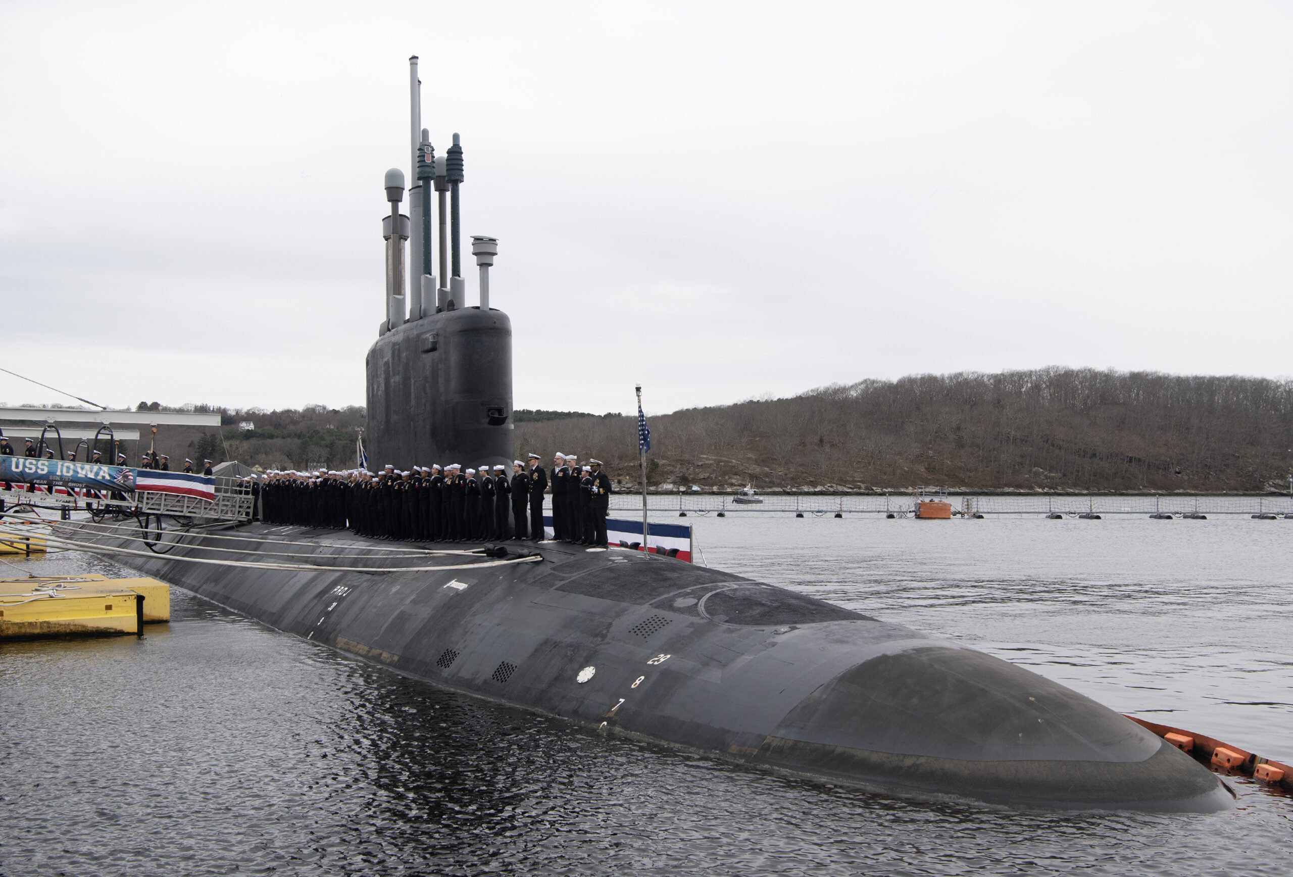 250405-N-UM744-1005- Sailors assigned to the Virginia-class fast attack submarine USS Iowa (SSN 797) man the rails during a commissioning ceremony at Naval Submarine Base New London in Groton, Conn. on April 5, 2025. SSN 797, the third U.S. Navy vessel to be named for “The Hawkeye State”, operates under Submarine Squadron (SUBRON) FOUR, whose primary mission is to provide attack submarines that are ready, willing, and able to meet the unique challenges of undersea combat and deployed operations in unforgiving environments across the globe. (U.S. Navy photo by John Narewski)