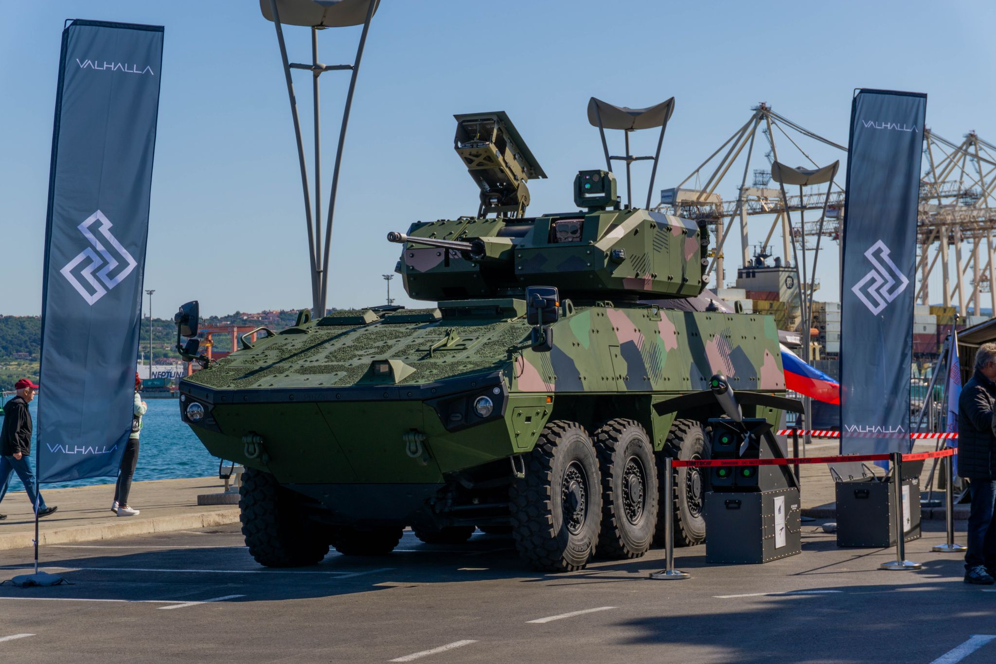 The Mangart 30 remote-controlled turret, integrated on a Patria 8x8 Armored Modular Vehicle. Two banners displaying Valhalla's logo are propped up on the vehicle's sides. The capability was unveiled during the Armed Forces Day celebration in Koper, southwest Slovenia.