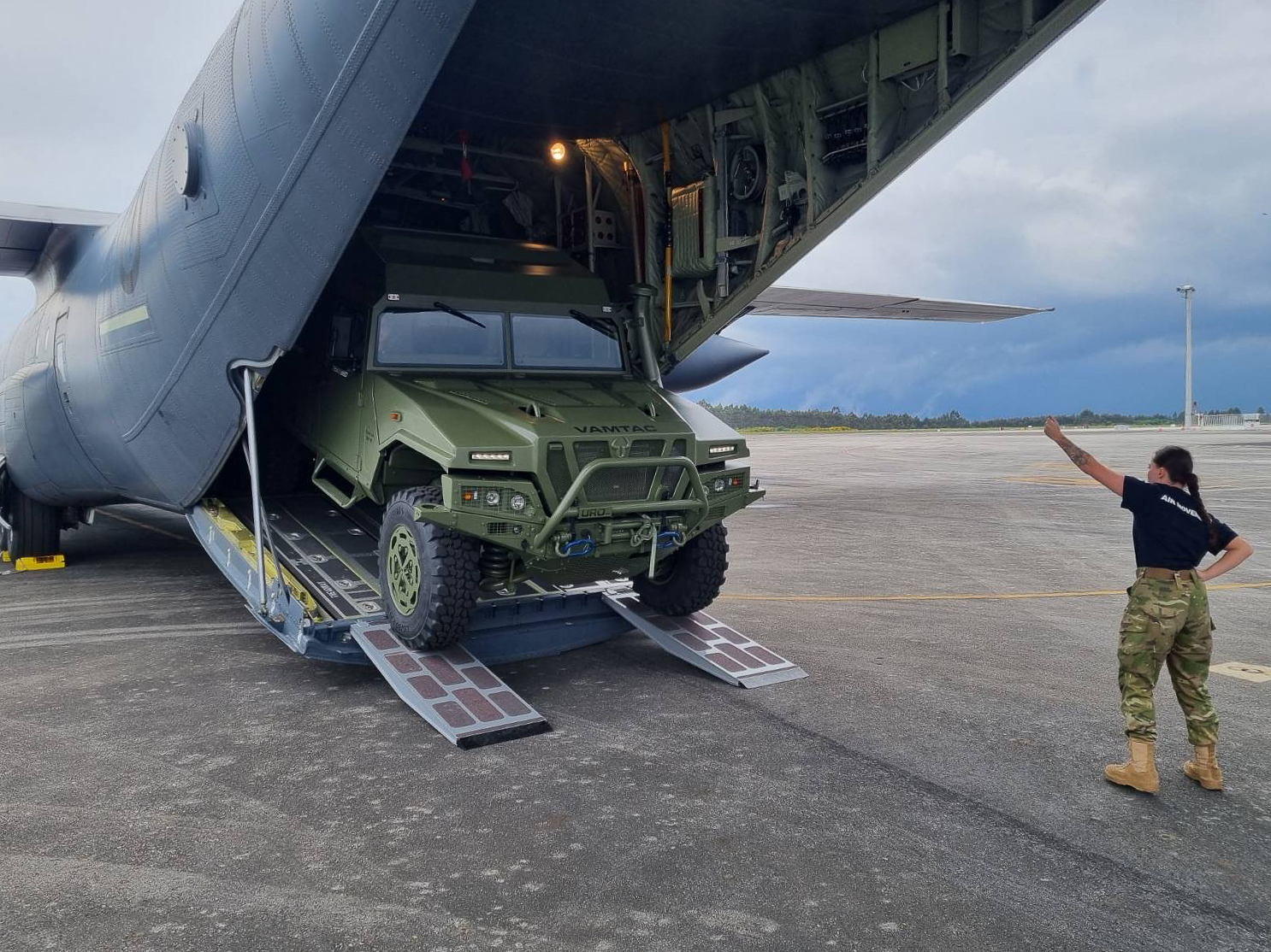 A VAMTAC ST5 4x4 vehicle being unloaded from a Super Hercules C-130J-30 aircraft