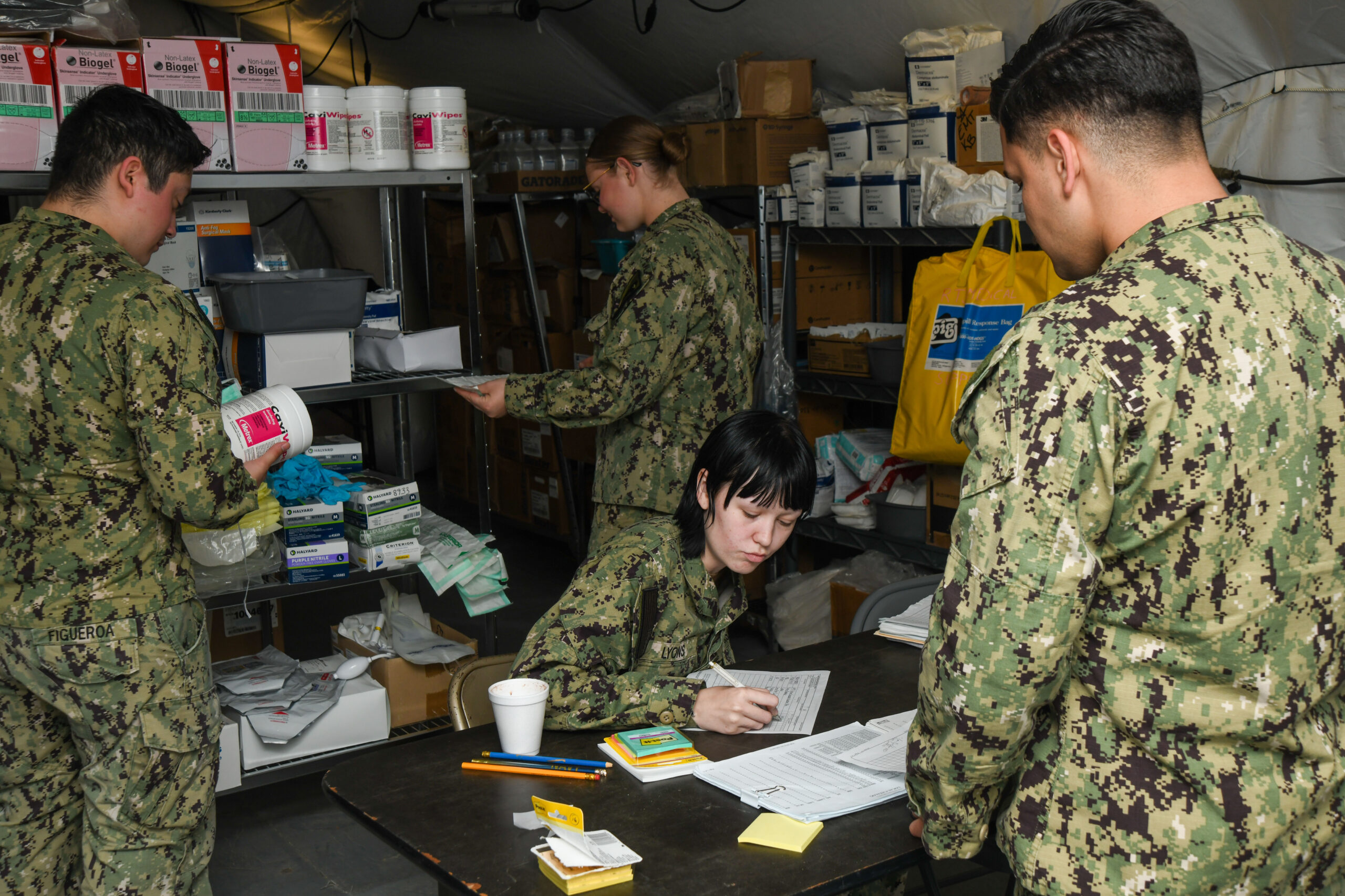 Sailors in the supply department fill a supply request during the Expeditionary Medical Facility Kilo (EMF-Kilo) Operational Readiness Exercise (ORE) on Fort McCoy, Wisconsin, April 29, 2025. EMF-Kilo is the readiness platform attached to Navy Medicine Readiness and Training Command Camp Lejeune and is comprised of approximately 400 personnel ready to deploy field hospital capabilities during humanitarian or combat mission.
