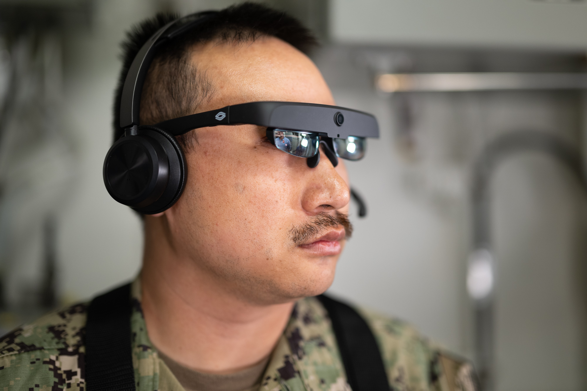 Naval Surface Warfare Center, Port Hueneme Division Fire Controlman Petty Officer 1st Class Donald Tran wears augmented reality glasses during an Augmented Reality Maintenance System demonstration aboard USS Spruance (DDG 111) on April 23. The headset allows a sailor underway to communicate in real time with a subject matter expert working shoreside, while the visor provides a visual of what the sailor sees.