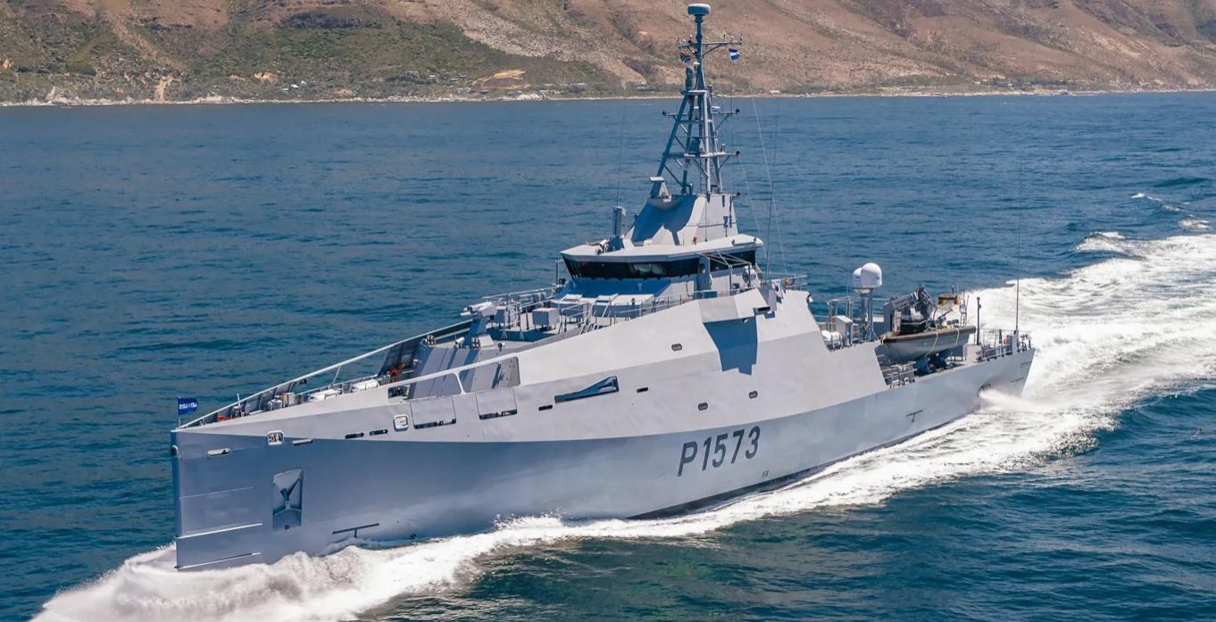 South African Navy's Multi-Mission Inshore Patrol Vessel (MMIPV), P1573, is seen sailing in deep blue waters. The ship is painted gray, with 'P1573' painted on the left side of its hull in black.