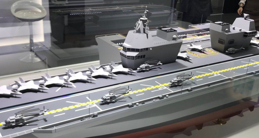 Conceptual model of a South Korean Navy aircraft carrier. The model has jet fighters and helicopters taxied on its deck. The ship is painted gray.