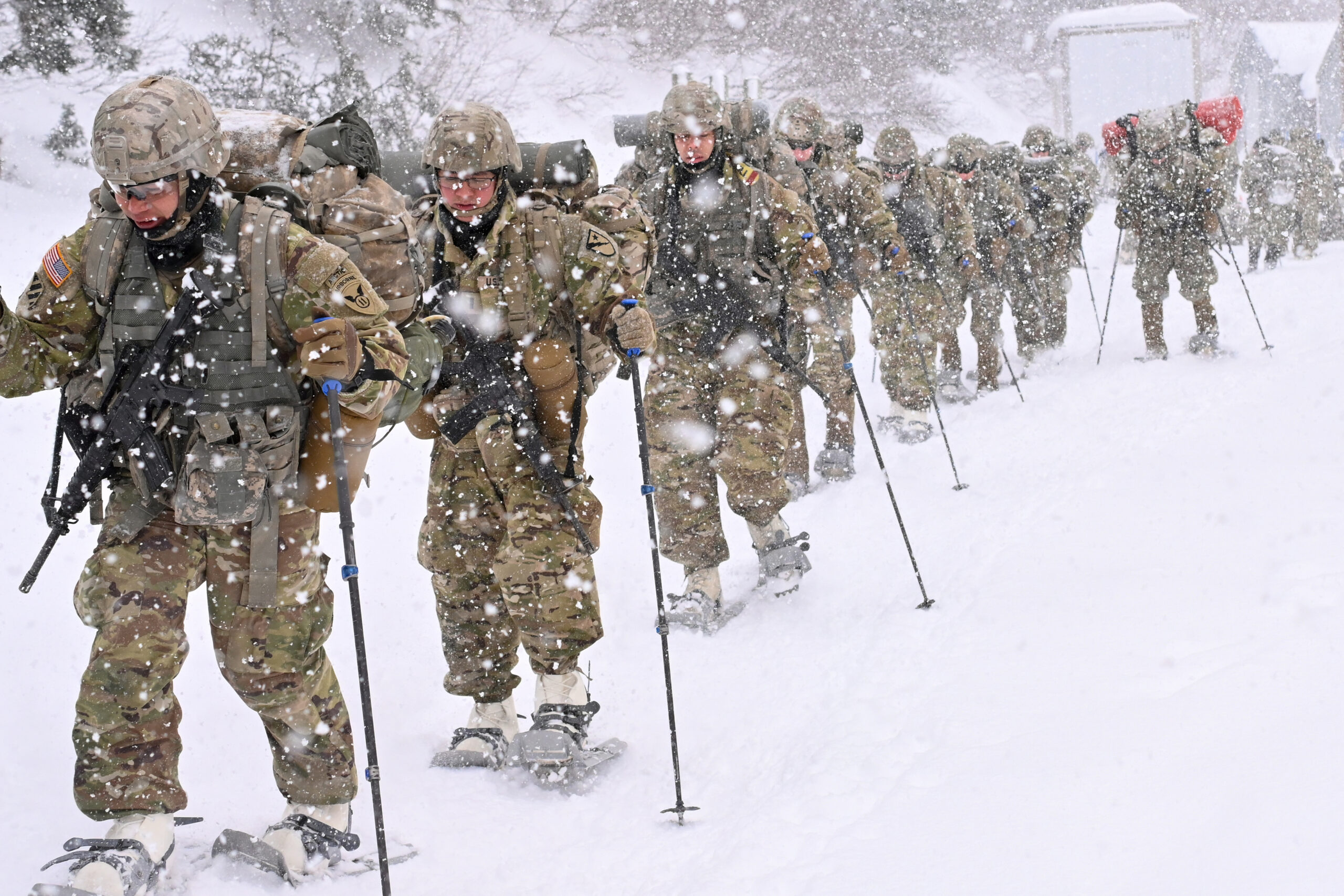 Cold Weather Leaders Course students move through the rugged terrain at the Northern Warfare Training Center's Black Rapids Training Site during a snowstorm. NWTC cadre worked overtime to help meet the increased need for more Arctic experts in the units to help pass critical knowledge throughout the formations. (Army photo/John Pennell)