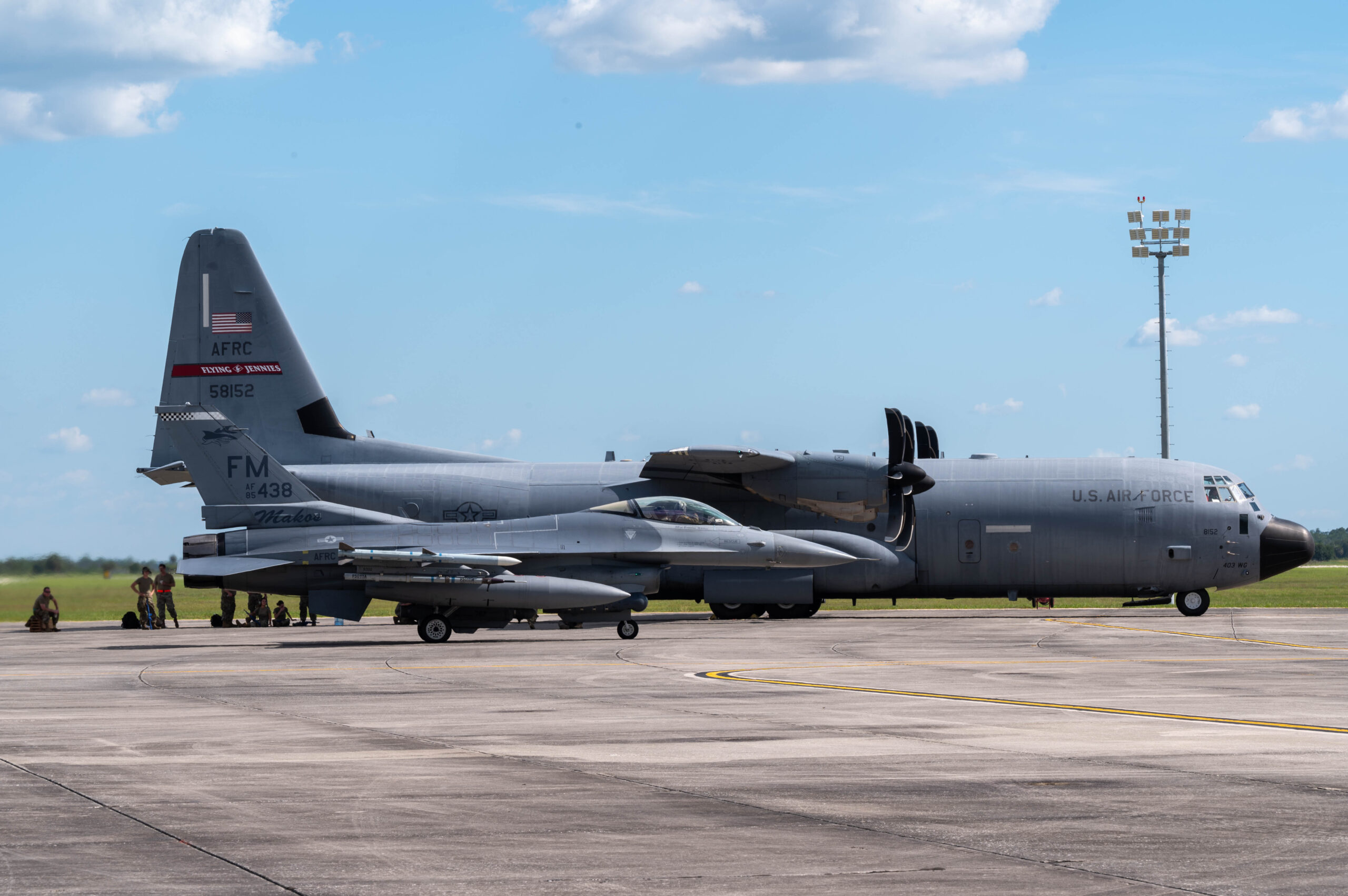 Airmen take a break in the shade after landing a C-130 cargo aircraft and refueling an F-16 fighter jet at Avon Park, Florida, June 6, 2022. Airmen nationwide participated in a week-long exercise in Jacksonville, Fla. called 