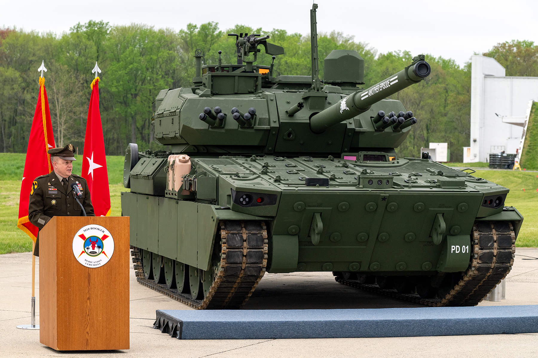 U.S. Army Brig. Gen. Geoffrey A. Norman the director of the Next Generation Combat Vehicle Cross Functional Team, gives his remarks on the M10 Booker Combat Vehicle during the M10 Booker Dedication Ceremony at Aberdeen Proving Ground, in Aberdeen, Md., April 18, 2024. The M10 Booker Combat Vehicle delivers overwhelming precision firepower to the Infantry Brigade, allowing it to maintain momentum and freedom of action against enemy forces. As part of the dedication of the M10 Booker Combat Vehicle in their name, U.S. Army Pvt. Robert D. Booker, a Medal of Honor recipient, and infantryman, assigned to the 133rd Infantry Regiment, 34th Infantry Division, during World War II, and Staff Sgt. Booker, a Distinguished Service Cross recipient, and tank crewman, assigned to Alpha Company, 1st Battalion, 64th Armor Regiment, 3rd Infantry Division, in support of Operation Iraqi Freedom, were recognized and honored for their ultimate sacrifice, heroism and commitment to service and country, represented by family members during the ceremony. (U.S. Army photo by Christopher Kaufmann)