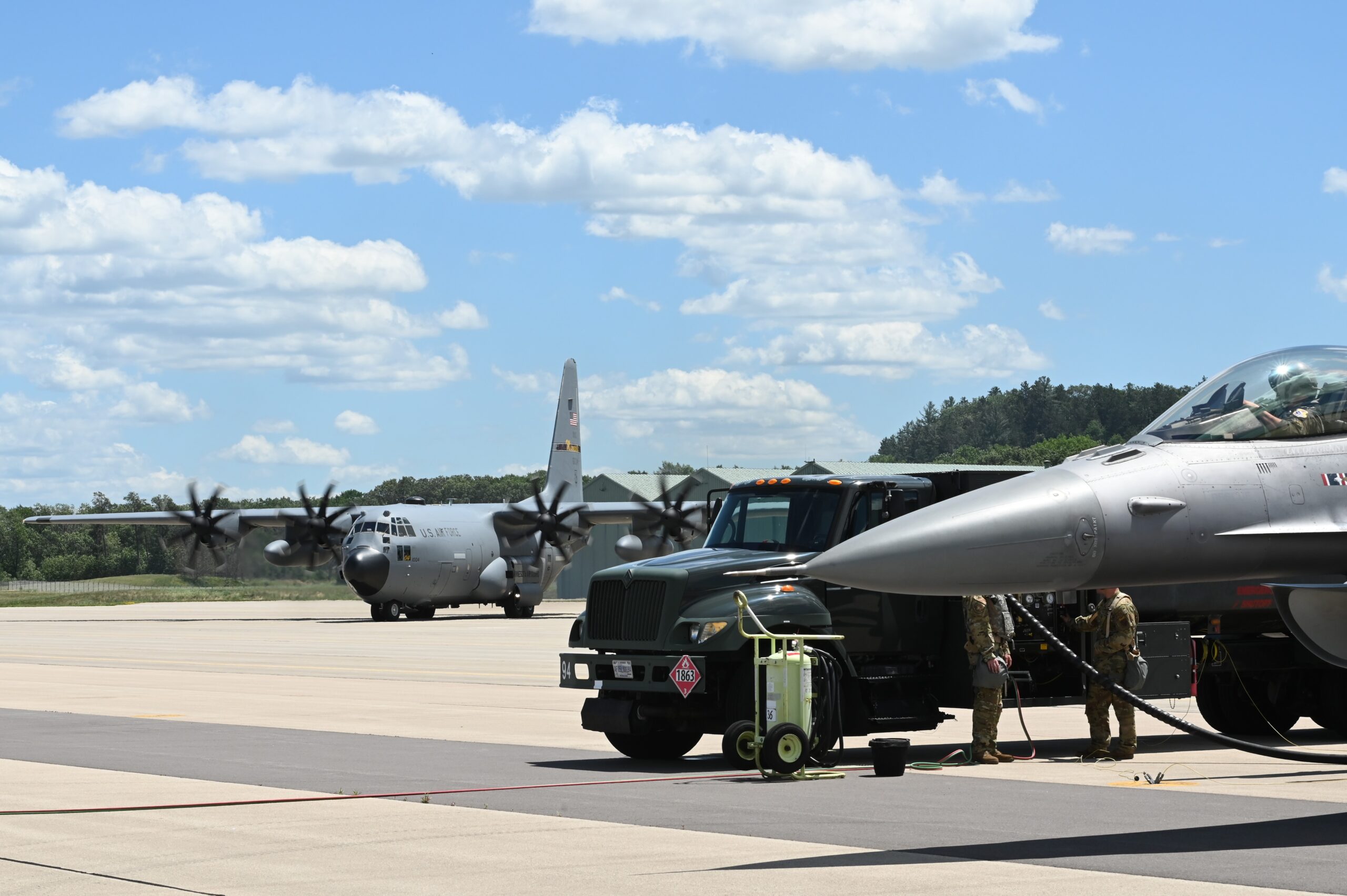 The 148th Fighter Wing and the 133rd Airlift Wing, Minnesota Air National Guard, collaborated during a 133rd Airlift Wing readiness exercise "Operation Mobility Gryphon" at Volk Field Combat Readiness Training Center, Wis., June 26, 2024. Airmen tested the ability to employ C-130 Hercules 'Hub and Spoke' operations in a simulated Pacific Air Command (PACOM) environment involving the Mobility Airlift Forces (MAF) and Combat Air Forces (CAF) working together. The MAF accomplished a Wet Wing Defuel of the C-130 before performing a Hotpit Refueling to F-16 Fighting Falcons, part of the CAF. (U.S. Air National Guard photo by A1C Addie Peterson)