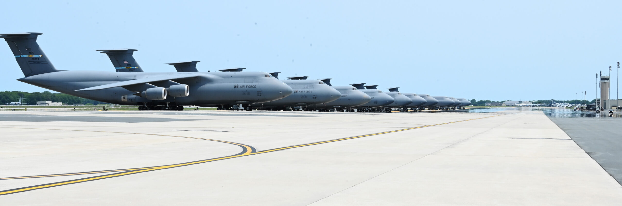 A group of C-5M Super Galaxy aircraft sits on the flightline June 3, 2025, at Dover Air Force Base, Delaware. The C-5M, with a cargo load of 281,001 pounds, can fly 2,150 nautical miles, offload and fly to a second base 500 nautical miles away from the original destination without aerial refueling. With aerial refueling, the C-5M's range is limited only by crew endurance. (U.S. Air Force photo by Jeremy Larlee)