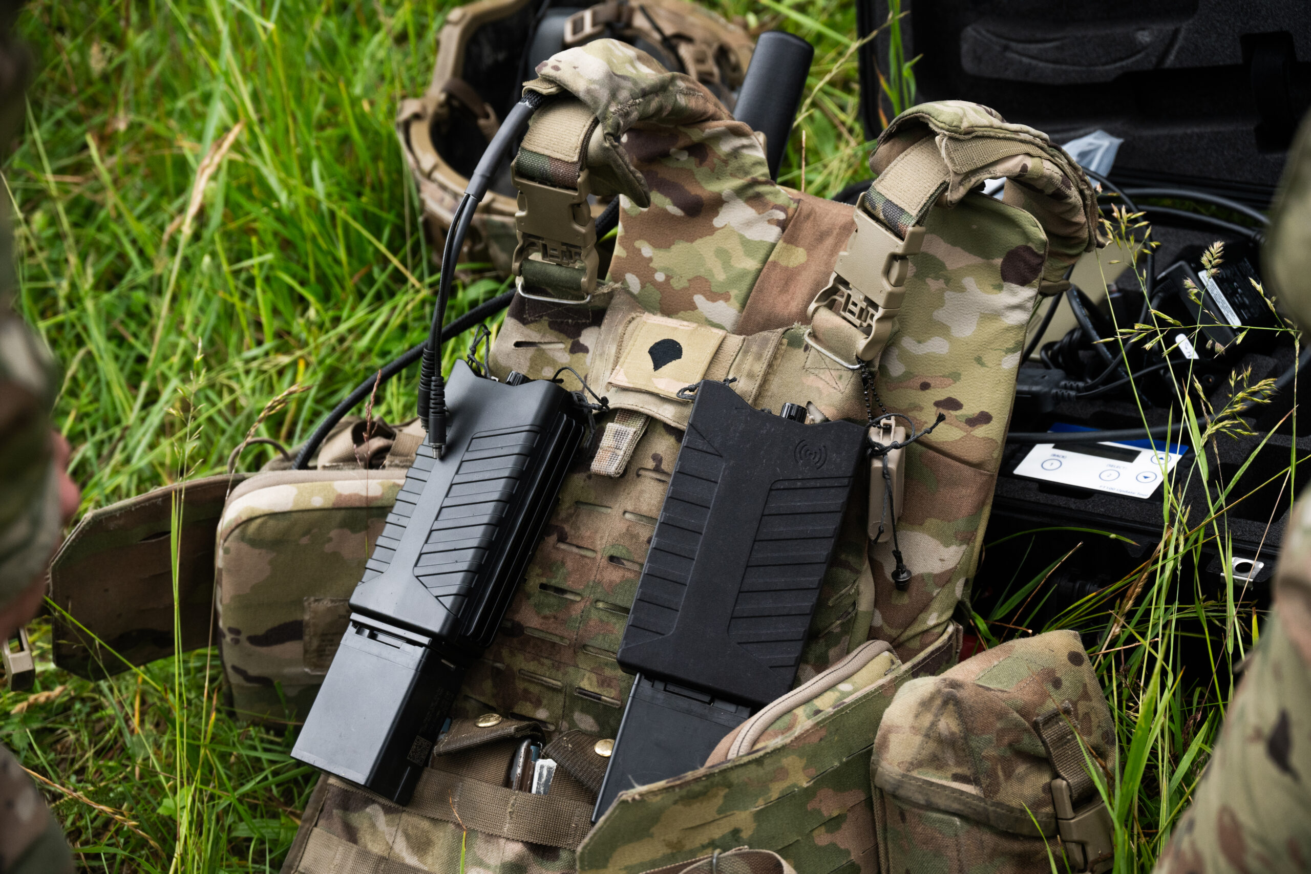 U.S. Soldiers assigned to 3rd Squadron, 2nd Cavalry Regiment mount the Wingman and Pitbull portable counter-unmanned aerial system devices to their modular tactical vests during Project Flytrap at Joint Multinational Readiness Center, Hohenfels Training Area, Hohenfels, Germany, June 7, 2025. The Wingman is a vest-mountable device capable of detecting nearby UAS threats, which then notifies the end-user to activate the Pitbull radio frequency jammer when a drone is in range. (U.S. Army photo by Spc. Elijah Magaña)
