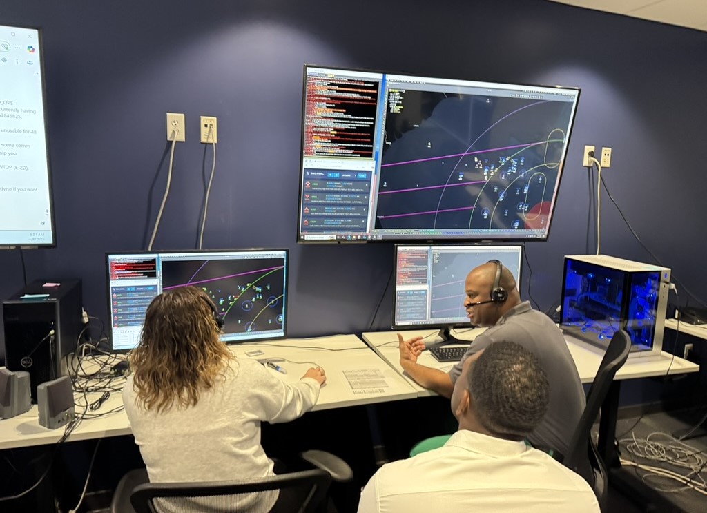 U.S. Air Force air battle managers participate in the Department of the Air Force’s Advanced Battle Management System Cross-Functional Team first Decision Advantage Sprint for Human-Machine Teaming, or DASH, experiment, recently held at the Howard Hughes Operations, or H2O, Center in Las Vegas, Nev., April 8, 2025. This two-week event brought together operational warfighters and industry and Shadow Operations Center-Nellis software developers to prototype microservices aimed at accelerating and improving decision-making in high-tempo battle management scenarios framed by the Transformational Model. (The image has been cropped to focus on the subjects.) (U.S. Air Force photo)