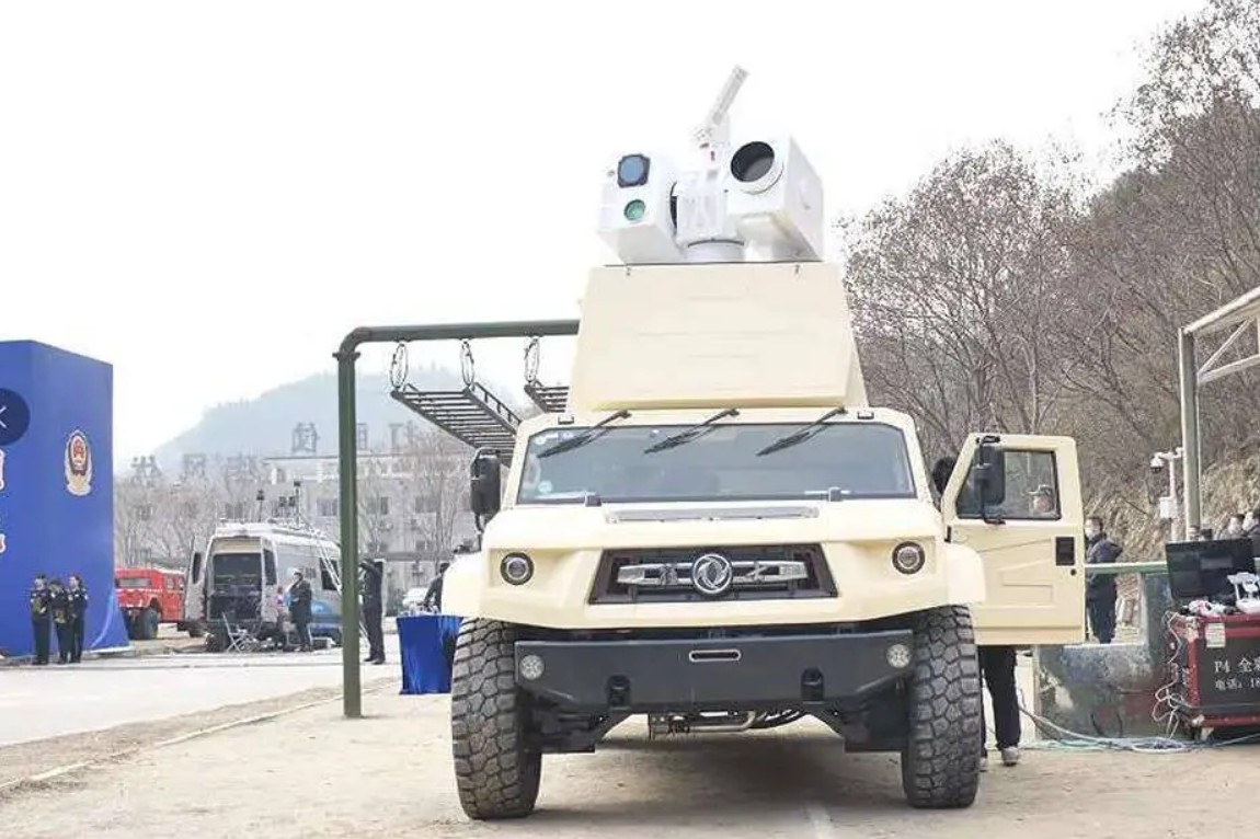 The Silent Hunter laser air defense system is seen installed atop an SUV-type vehicle. The system and vehicle are both painted dirty white.