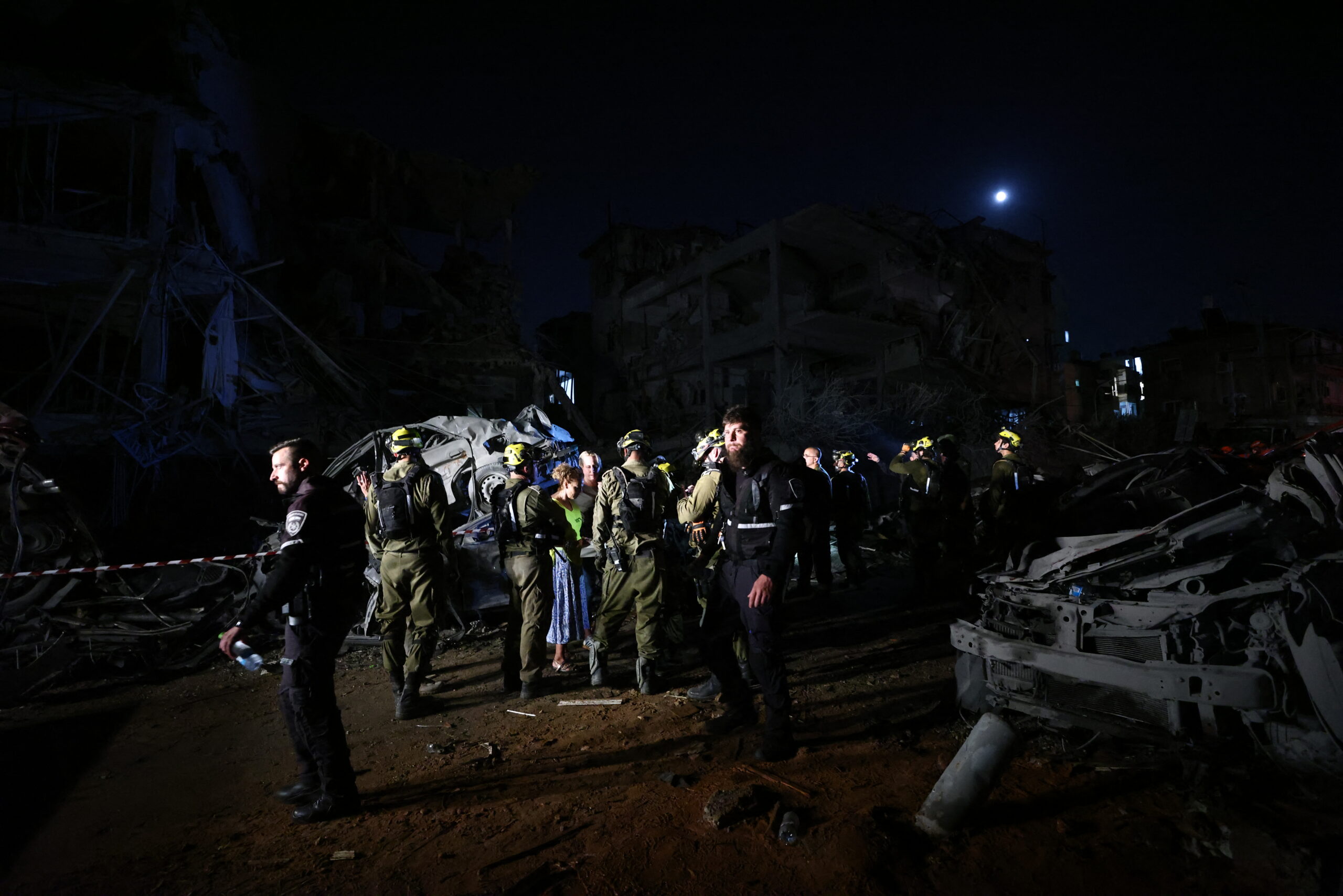 Israeli first responders arrive at a site hit by a missile fired from Iran in central Israel