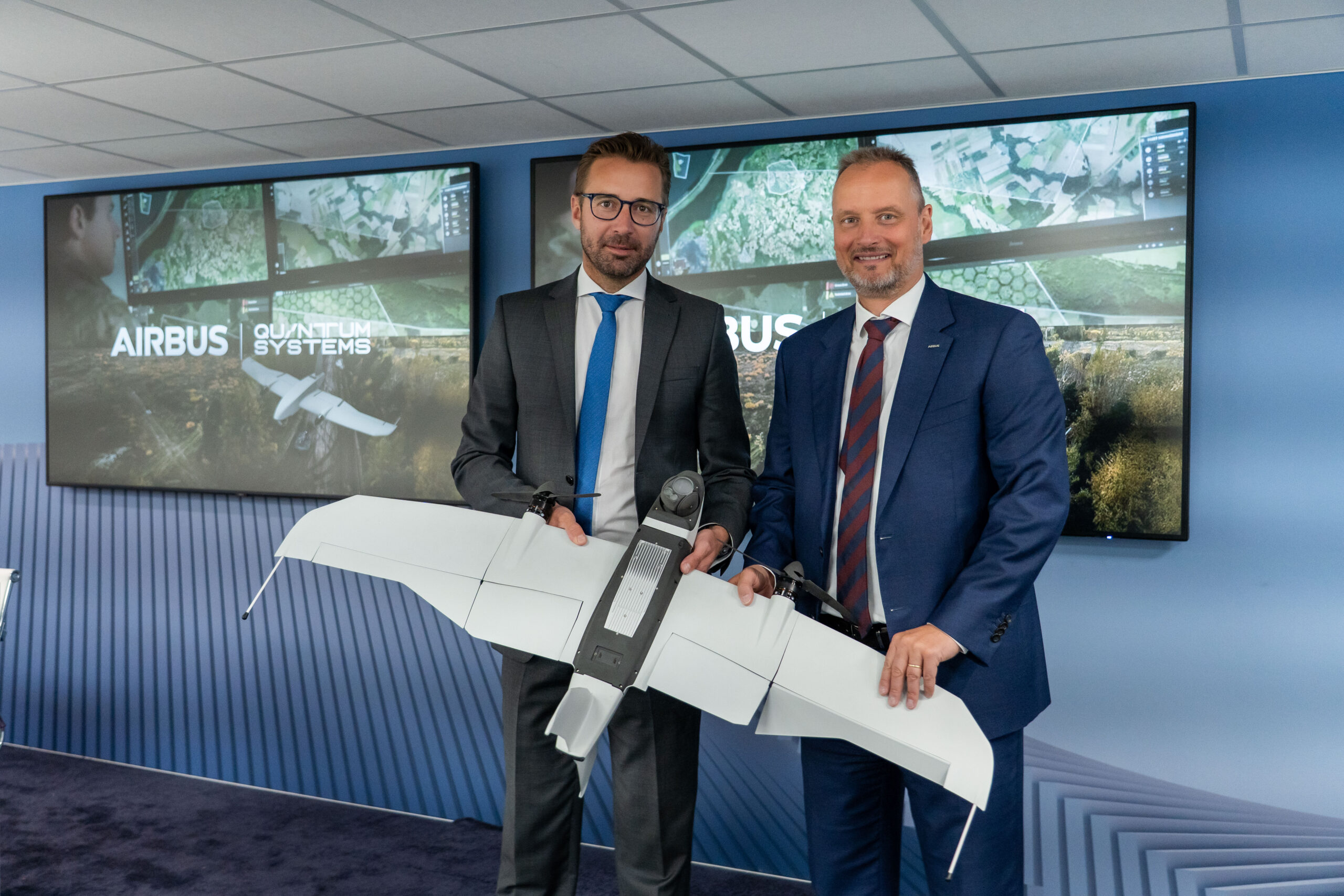 Airbus and Quantum Systems officials holding an unmanned aerial system