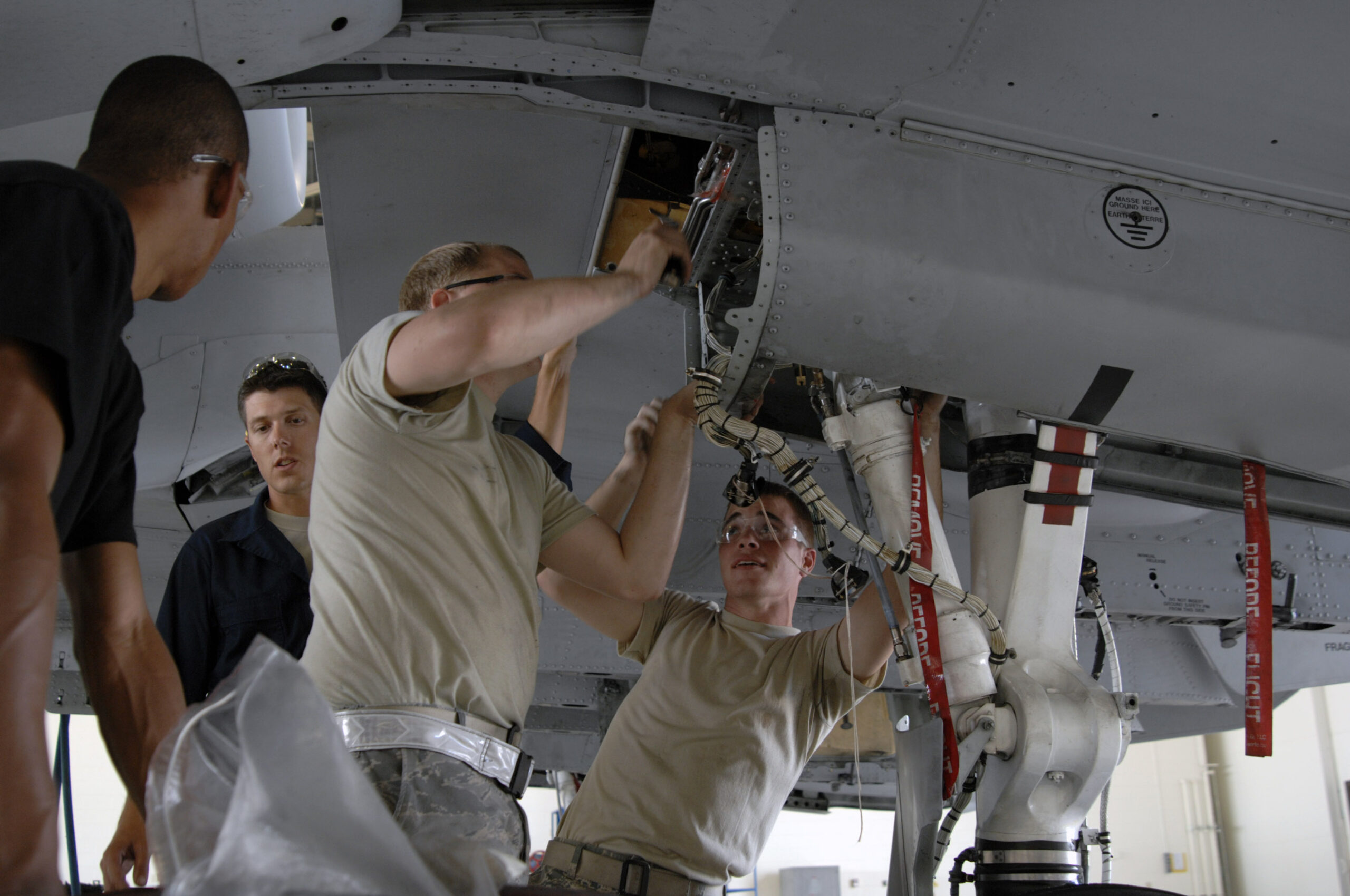 Maintainers at Moody Air Force Base prepare to inspect an A-10 Thunderbolt II for wing frame cracks
