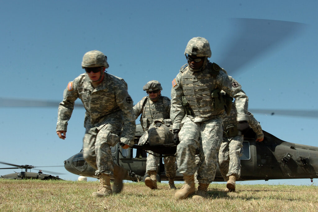 Soldiers from the 154th Transportation Company, 180th Transportation Battalion, 15th Sustainment Brigade, 13th Sustainment Command (Expeditionary), carry a fellow Soldier away from a medical evacuation helicopter during medevac training on Oct. 2, 2008, at Fort Hood.