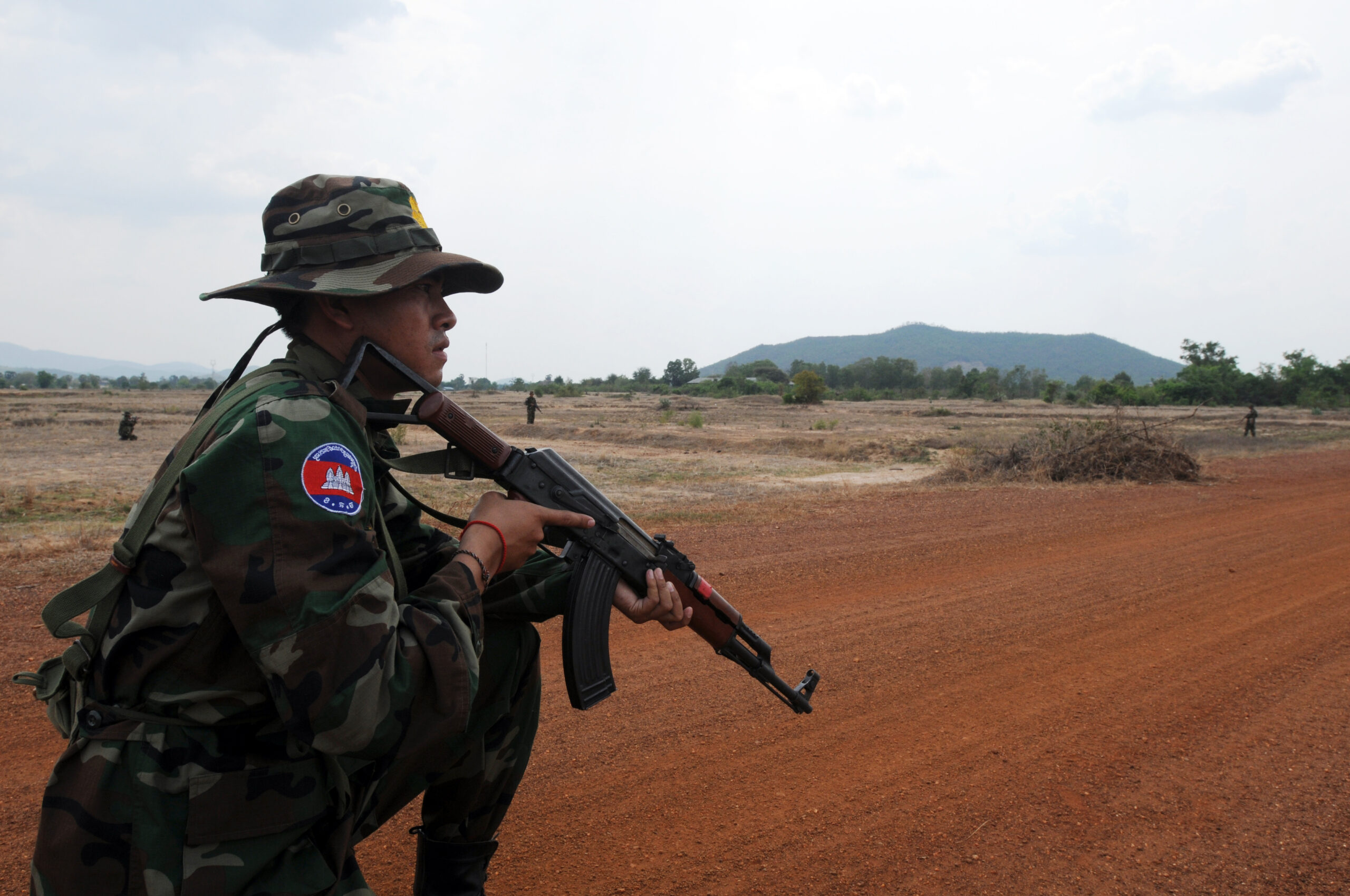 A Royal Cambodian Armed Forces soldier reacts to a simulated improvised explosive device hidden inside bushes along the roadway during Counter-IED training at the Peacekeeping Operations School in Kampong Speu province, March 15. Idaho Army National Guard soldiers partnered with RCAF during Angkor Sentinel 2012, an annual bilateral military exercise sponsored by U.S. Army Pacific and hosted by Cambodian forces.