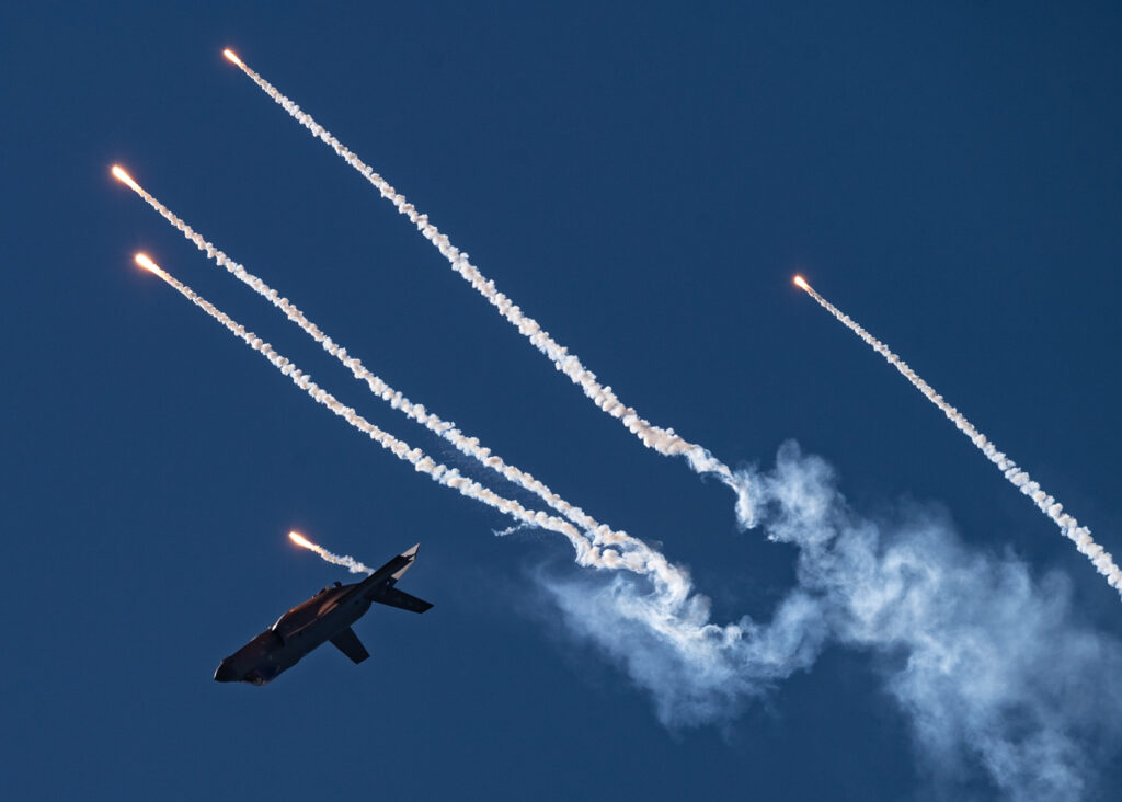U.S. Air Force Maj. Kristin "BEO" Wolfe, F-35A Lightning II Demonstration Team pilot and commander, deploys flares during her aerial demonstration at the Pacific Air Show, Oct. 2, 2021, Huntington Beach, Calif. This was the first time the F-35 Demo Team deployed flares at a public performance. (U.S. Air Force photo by Capt. Kip Sumner)