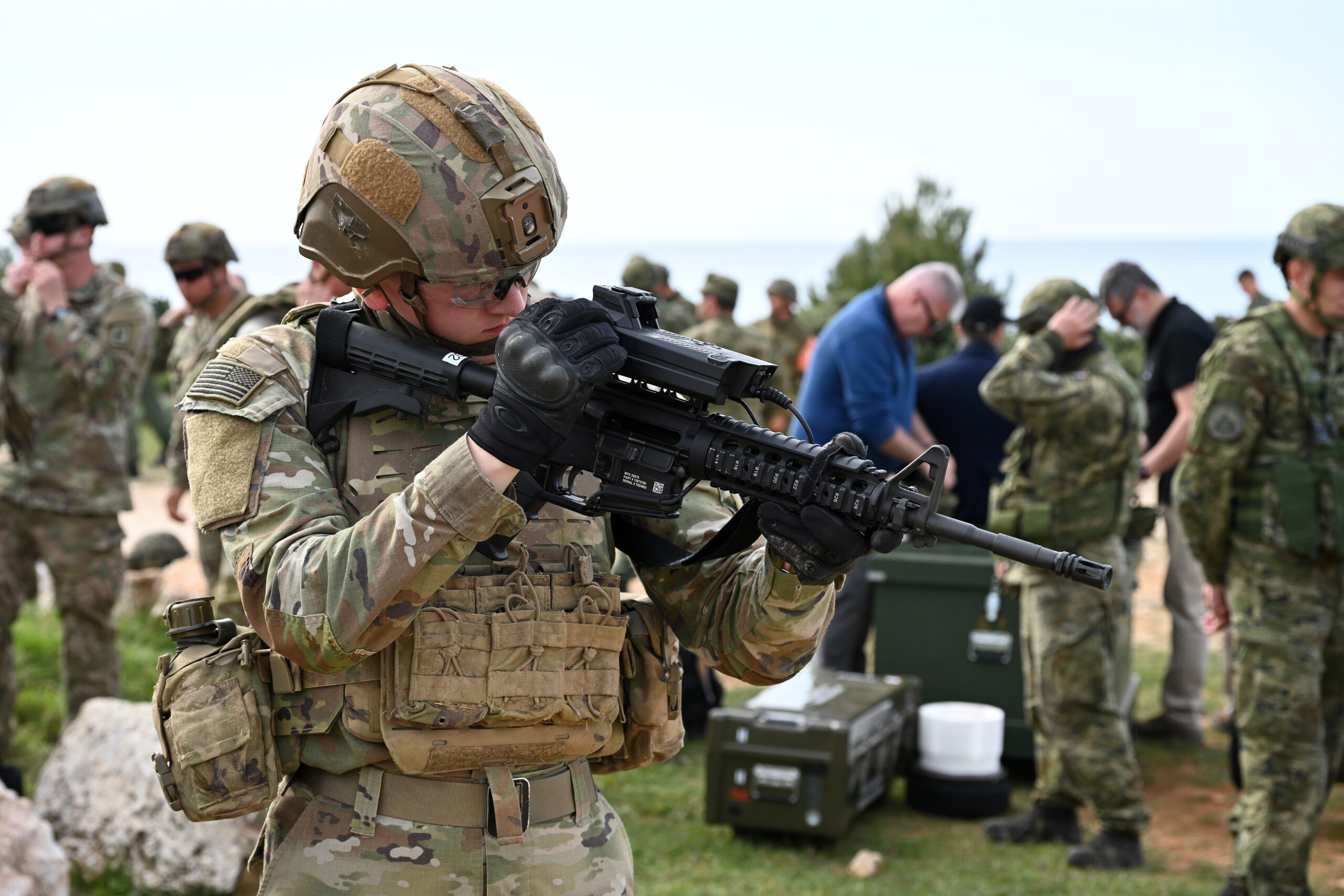 A Paratrooper from the 173rd Airborne Brigade prepares his M4 Carbine with the SMASH 3000 during the Operation Shield 25, on April 10, 2025 in Kamenjak near Medulin , Pula, Croatia. This annual event bolsters Croatian air defense capabilities against low and medium-altitude threats. Joined by international partners, including and the Croatian Army, Slovenian Army, British Army and French Armed Forces, the exercise emphasizes air defense tactics and live-fire engagements. The 173rd Airborne Brigade is the U.S. Army's Contingency Response Force in Europe, providing rapidly deployable forces to the United States European, African, and Central Command areas of responsibility. Forward deployed across Italy and Germany, the brigade routinely trains alongside NATO allies and partners to build partnerships and strengthen the alliance. (U.S. Army photo by Paolo Bovo)