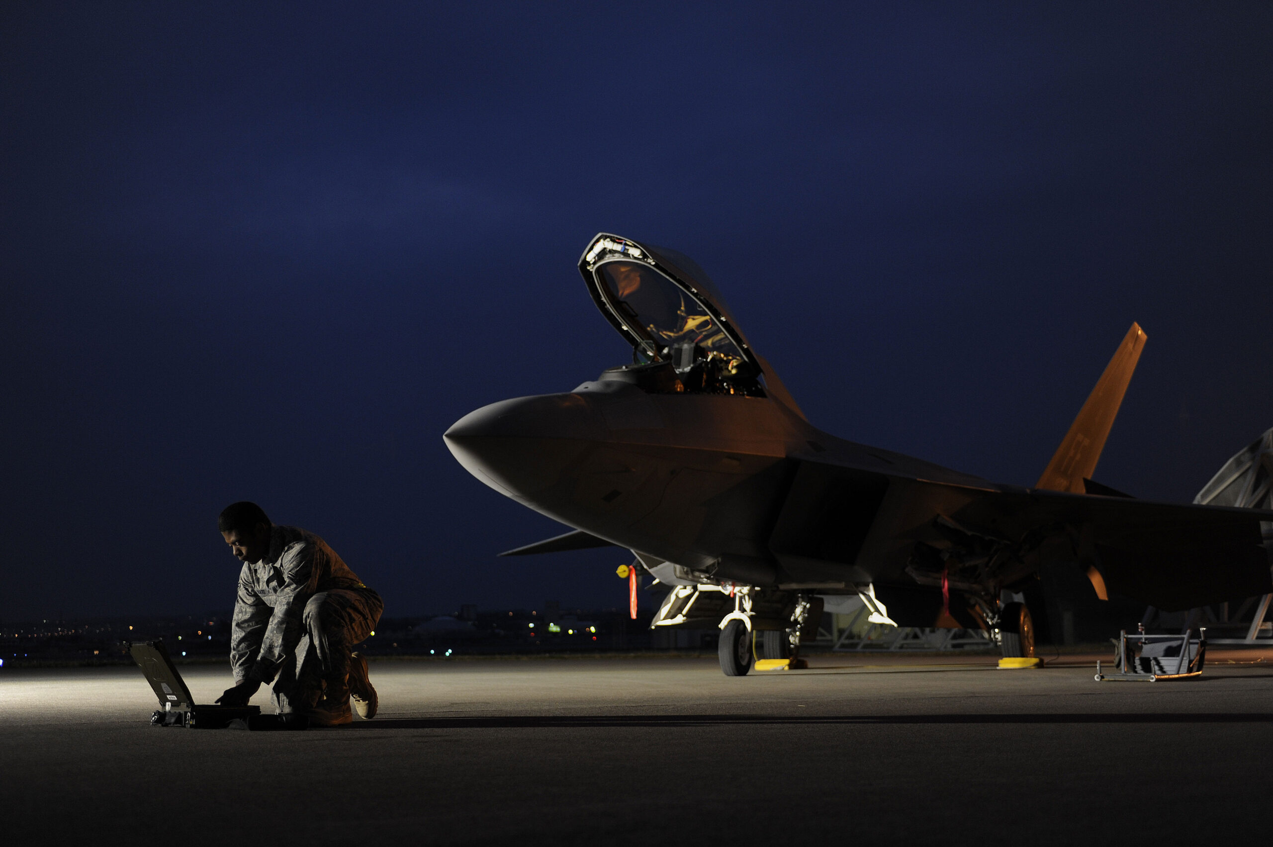 U.S. Air Force Airman 1st Class Aaron Tate enters data into his portable maintenance computer in front of an F-22A Raptor aircraft at Kadena Air Base, Japan, on Jan. 21, 2009. Tate and the jet are deployed from the 27th Fighter Squadron at Langley Air Force Base, Va. (DoD photo by Master Sgt. Andy Dunaway, U.S. Air Force. (Released))