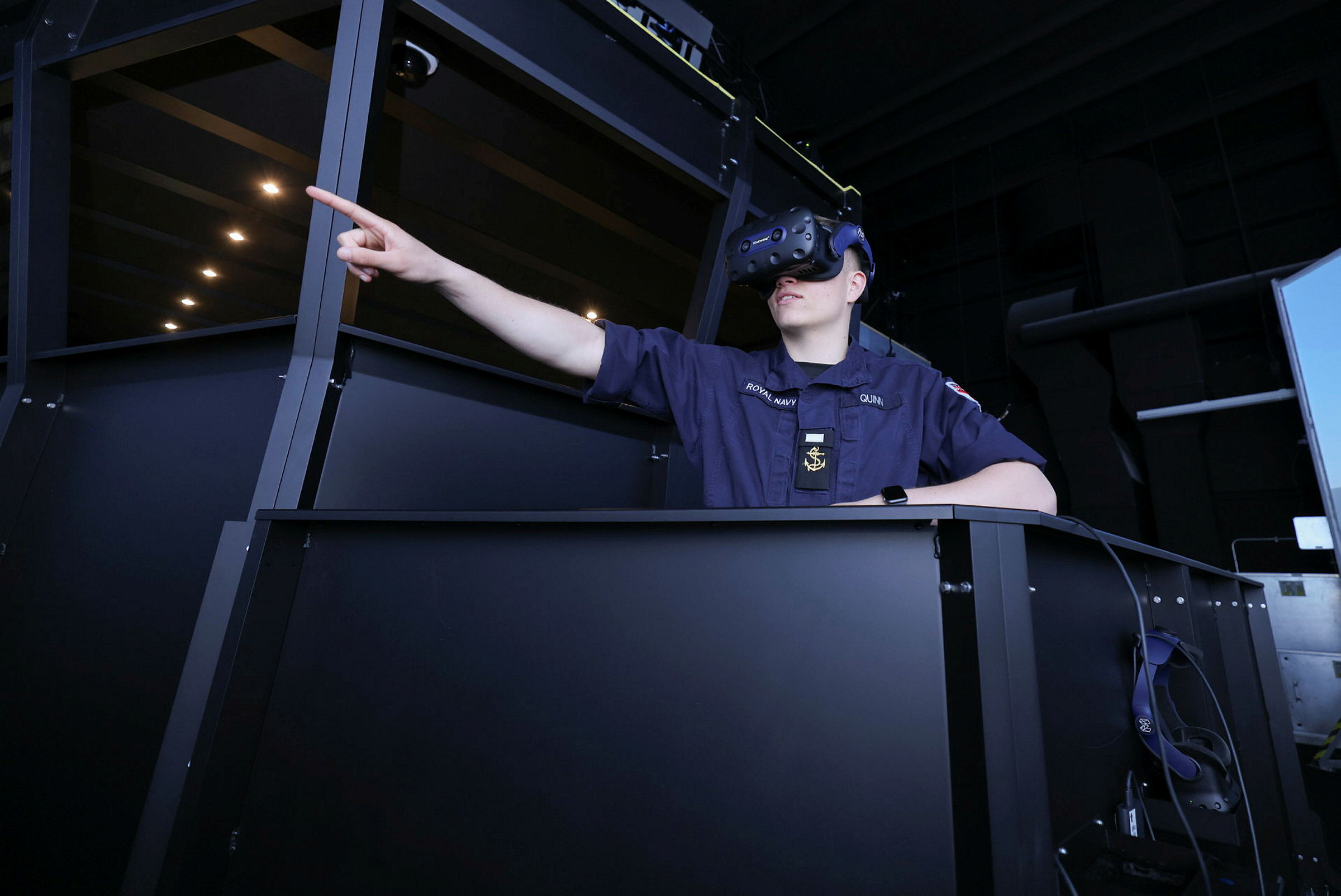 The Royal Navy is embracing Virtual Reality to train sailors guiding warships on operations worldwide. Shown here is LH Quinn conducting training within the virtual reality training simulator. Nine hi-tech bridge simulators – which accurately recreate both the bridge of present-day warships, but also the key waters and harbours they operate in – have been installed at sites in England and Scotland, led by the Navy’s warfare school at HMS Collingwood in Fareham. The £27m investment in partnership with Team Fisher, (a consortium of partners led by Capita which delivers shore-based training for the Royal Navy) and Metaverse VR, is intended to make learning navigation and running a bridge more realistic, better and potentially faster. Five simulator suites have been installed at HMS Collingwood: two large ‘full mission’ simulators with wrap-around digital display screens and virtual reality headsets, a smaller version with an LCD display and finally two small trainers – more akin to a video gaming set-up, but with the same features/accuracy as their full-size counterparts.