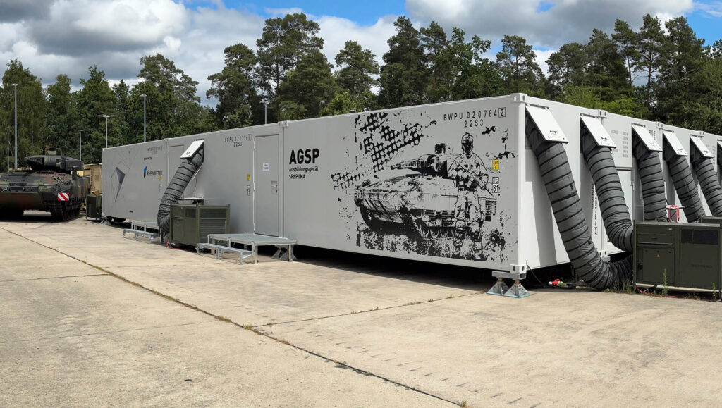 Infantry Fighting Vehicle Puma beside Rheinmetall's mechanized vehicle simulator